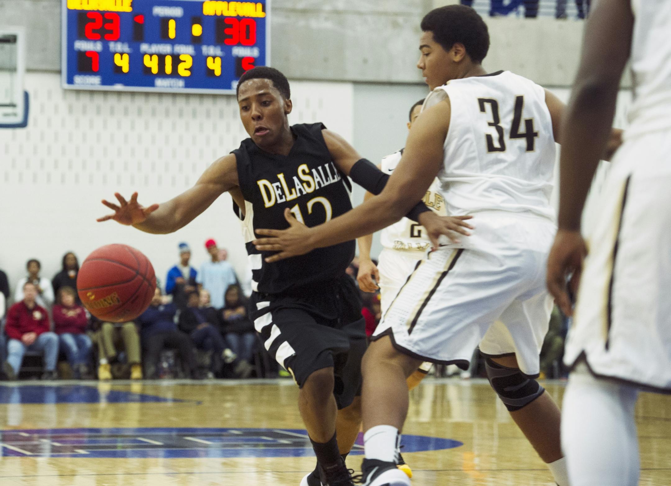 DeLaSalle's Jarvis Johnson loses control of the ball as he drives to the hoop during the first half of the Breakdown Tipoff Classic, Friday, December 7th, 2013.