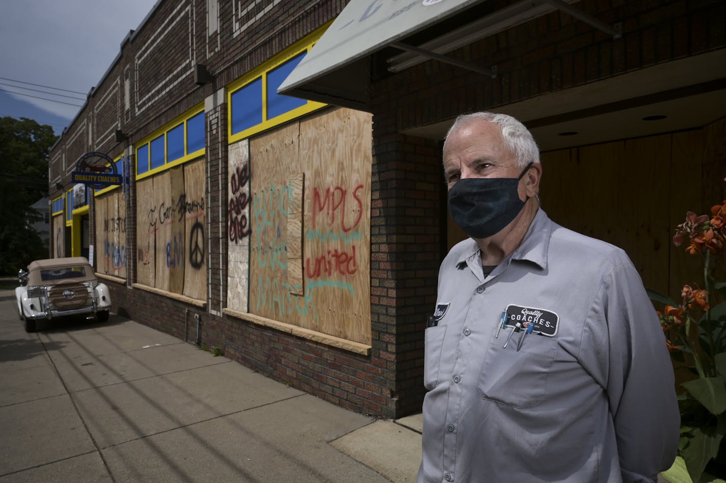 Mark Brandow, owner of Quality Coaches auto shop, stood for a portrait outside the shop, still boarded up, on Thursday, Aug. 20, 2020 in Minneapolis, Minn. ] aaron.lavinsky@startribune.com