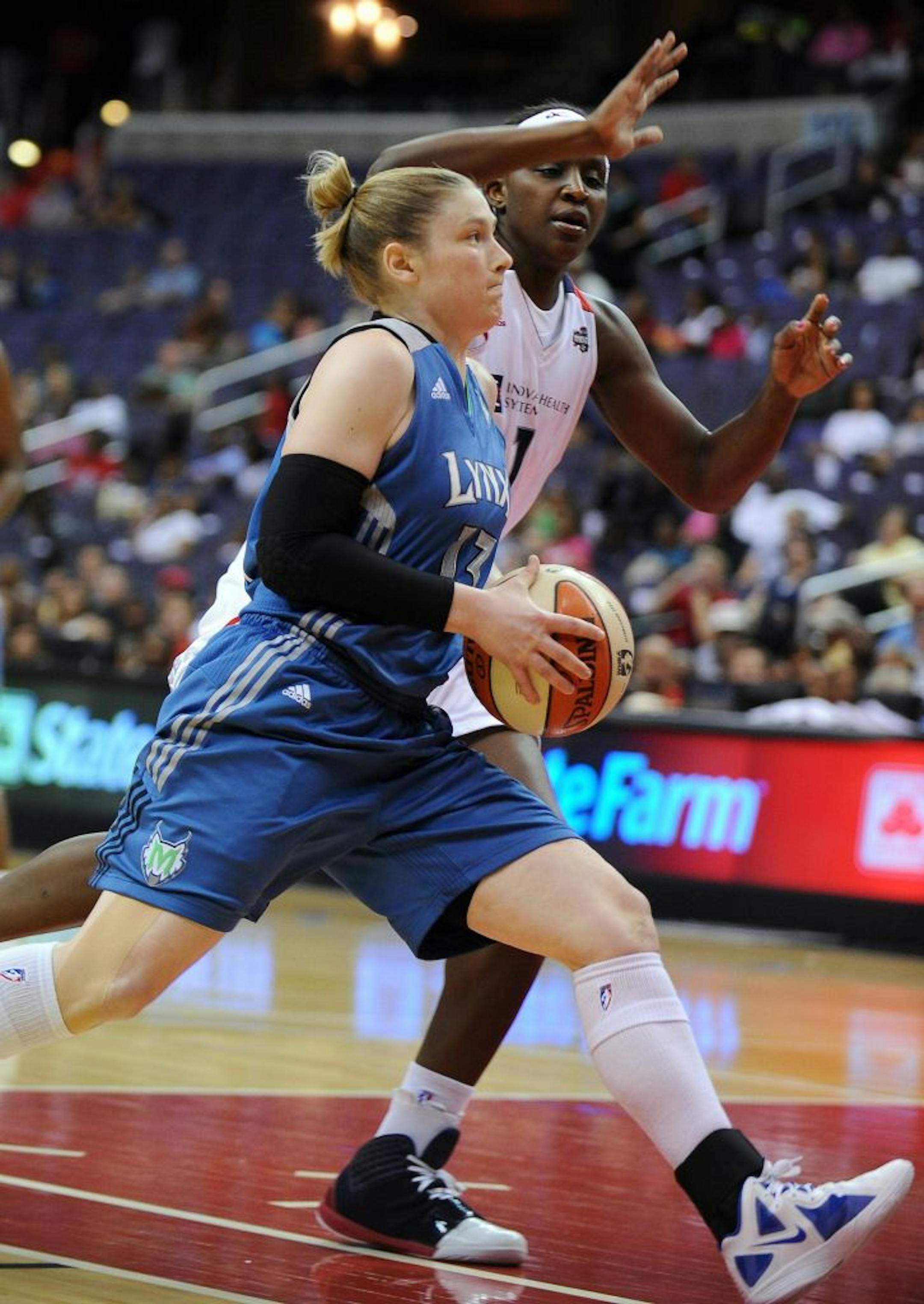 Lynx guard Lindsay Whalen drove to the basket against Washington forward Crystal Langhorne during the first quarter Thursday.