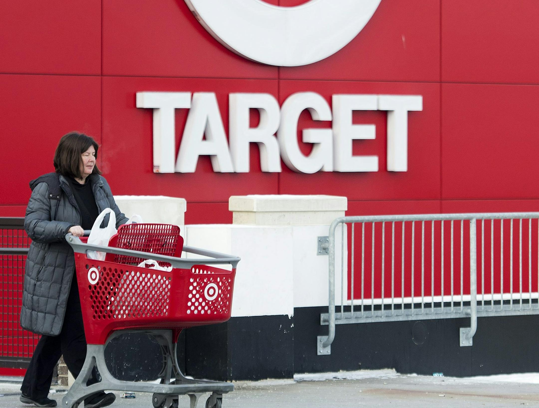Shopper Laura Steele leaves a Target store in Toronto on Thursday, Jan. 15, 2015. More than 17,600 Target employees will eventually lose their jobs when the U.S. discount retailer closes its 133 Canadian stores after only about two years to end financial losses that went as high as a billion dollars a year. (AP Photo/The Canadian Press, Nathan Denette)