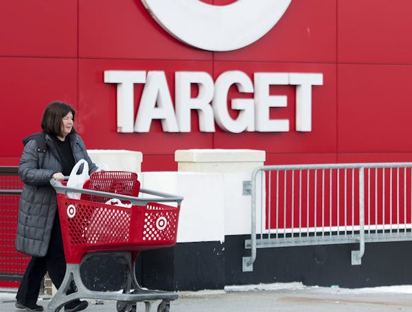 Shopper Laura Steele leaves a Target store in Toronto on Thursday, Jan. 15, 2015. More than 17,600 Target employees will eventually lose their jobs wh