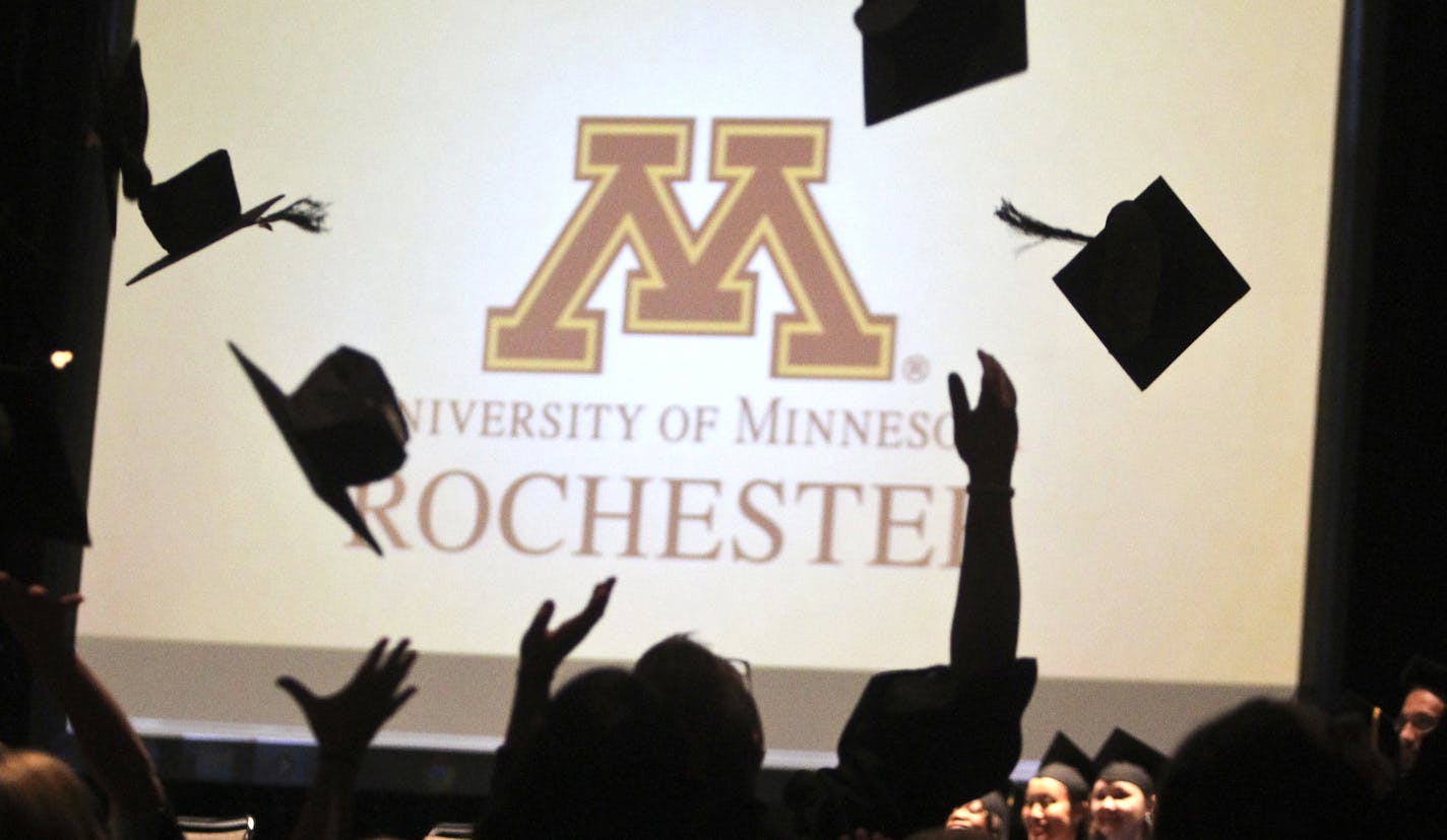 Following the graduation ceremony, the first-ever class of graduates at the University of Minnesota, Rochester toss their mortar boards into the air at the Mayo Civic Center Saturday, May 18, 2013 in Rochester, MN.] JOLES/STARTRIBUNE) djoles@startribune The first-ever class of undergrads at the University of Minnesota, Rochester graduate this weekend. When they began as freshmen, there were no dorms, no upperclassmen, no mascot. ORG XMIT: MIN1305181518000499