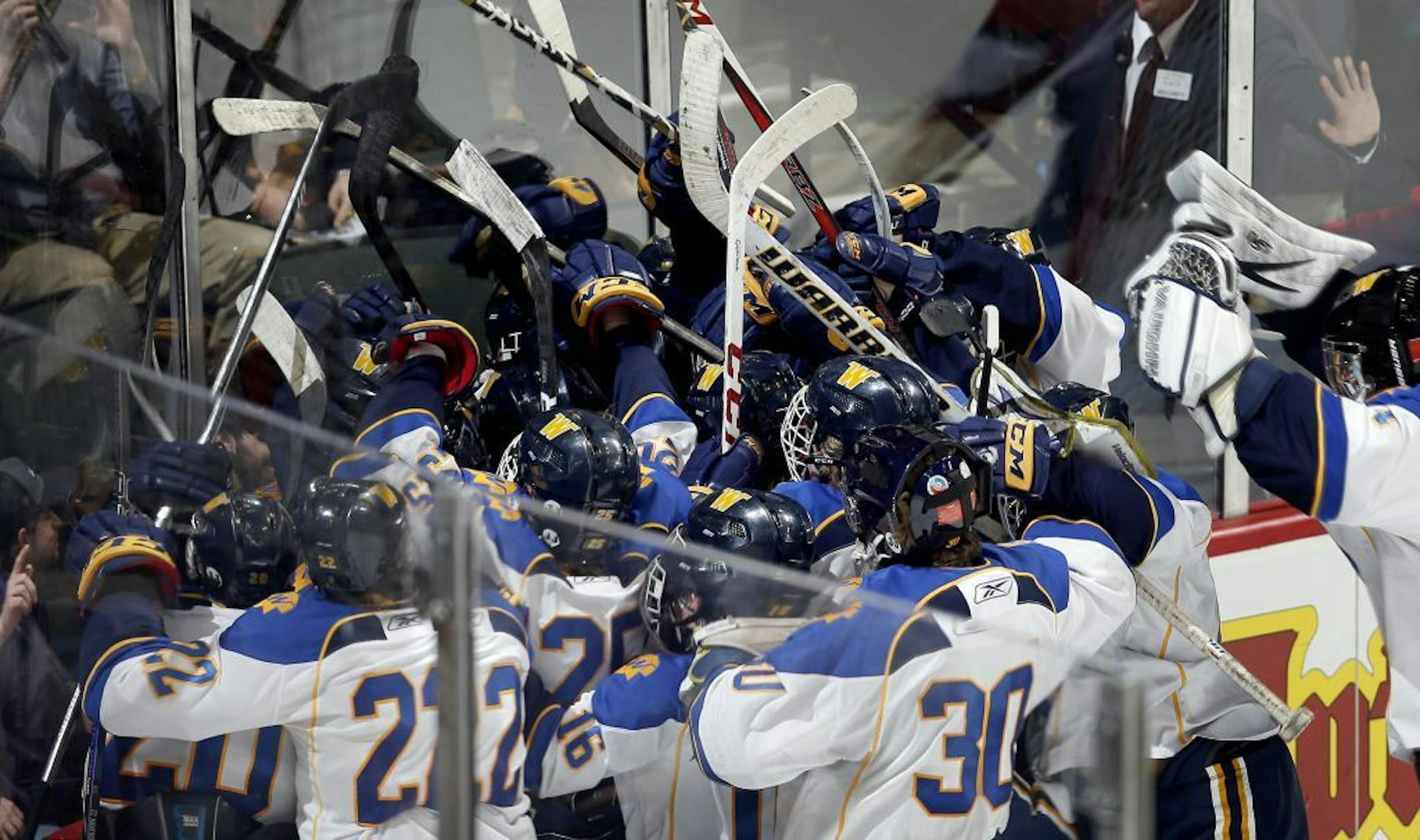 Wayzata celebrated after a game winning goal by Chase Heising (11) in overtime.