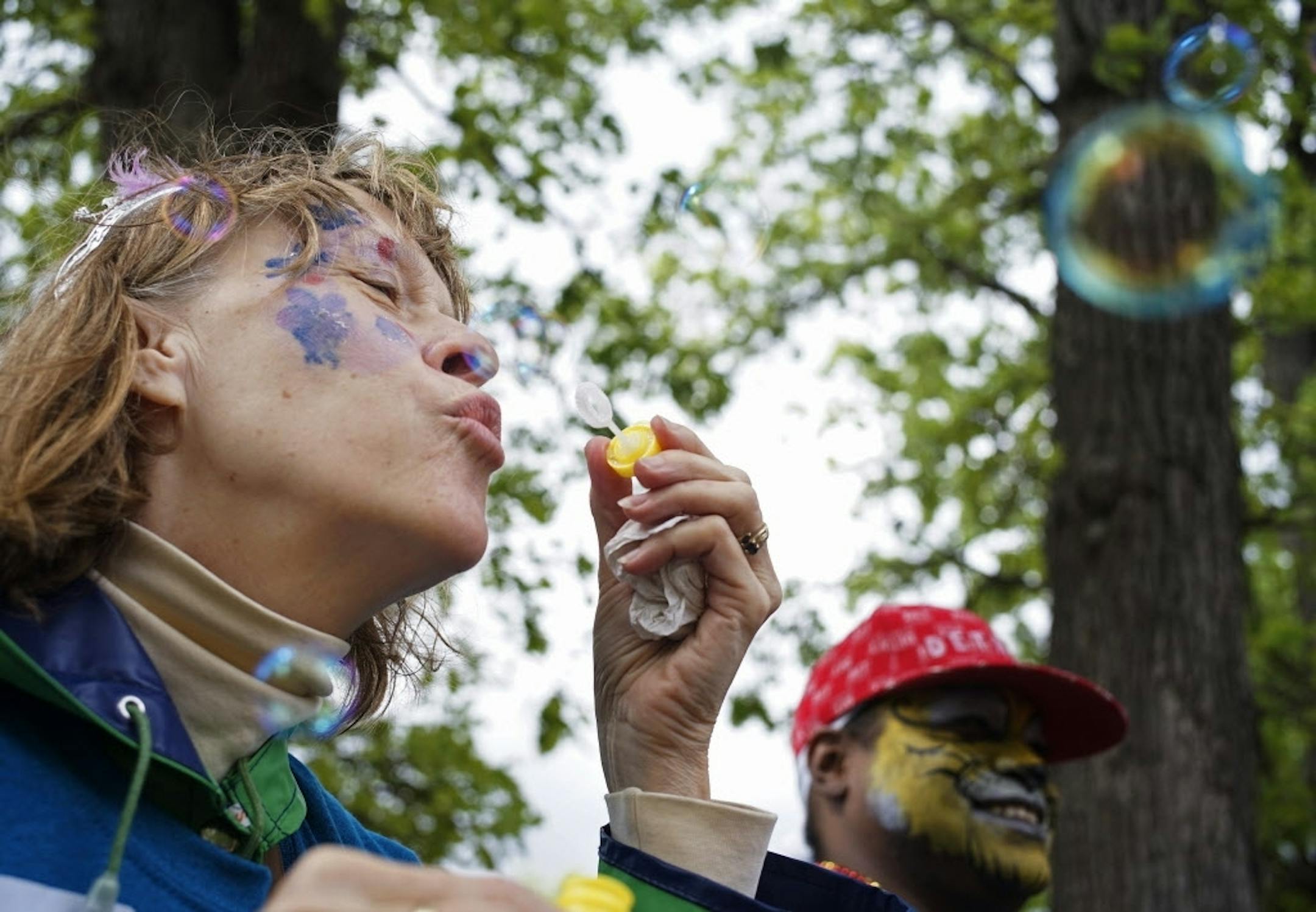 At the start of the MN AIDS Walk 2015 held at Minnehaha Park, volunteer Sue Rohland, part of the welcome squad, blew some bubbles.