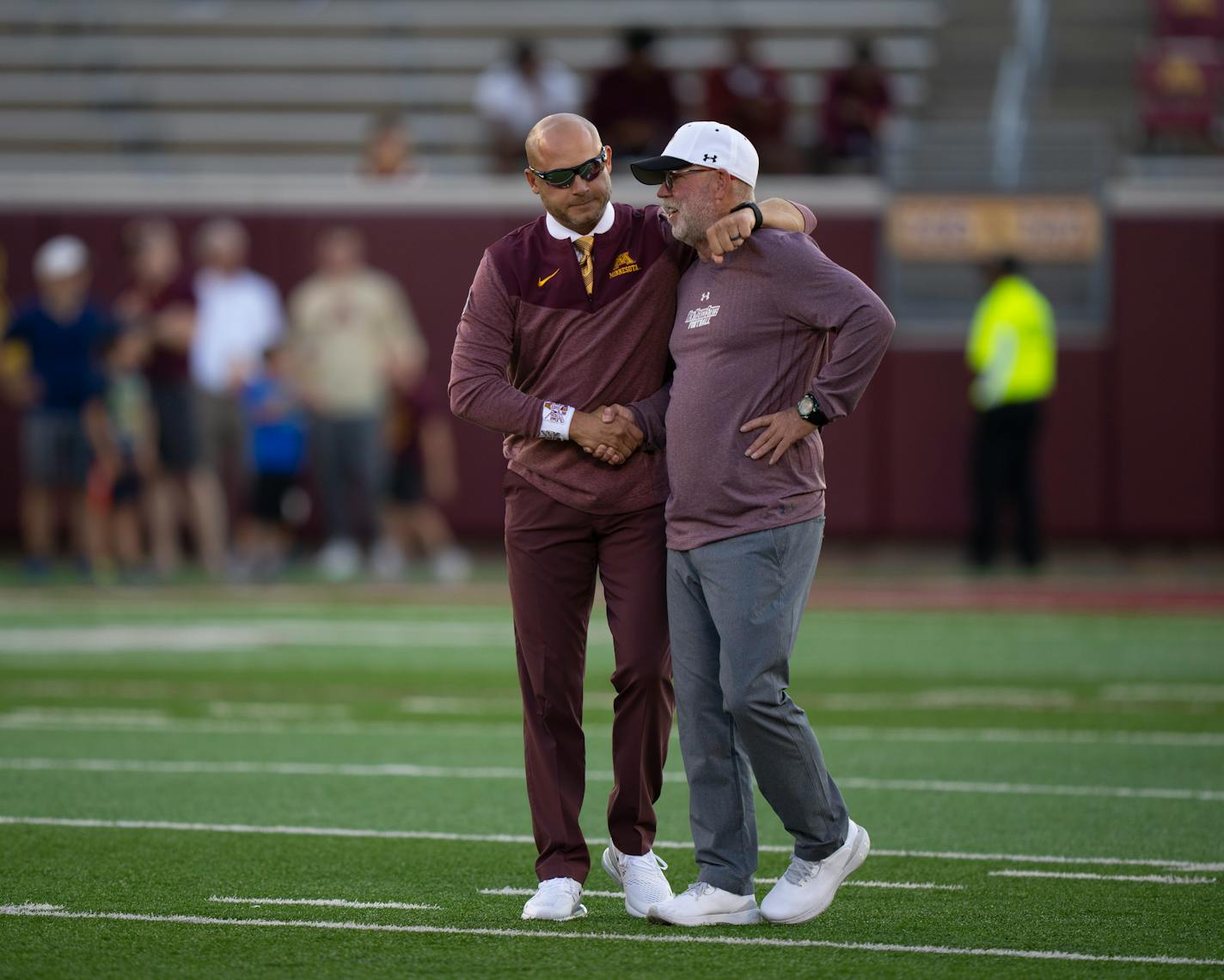 Gophers coach P.J. Fleck, left, and New Mexico State coach Jerry Kill exchanged greetings on the field as their teams warmed up before their game at Huntington Bank Stadium