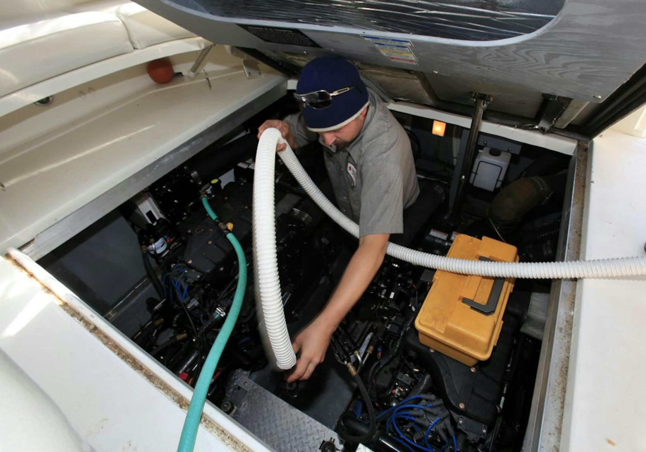 Boat mechanic, Chris Calverley winerizes the boat before it is lifted out of the water. Bayport, MN on September 24, 2012.