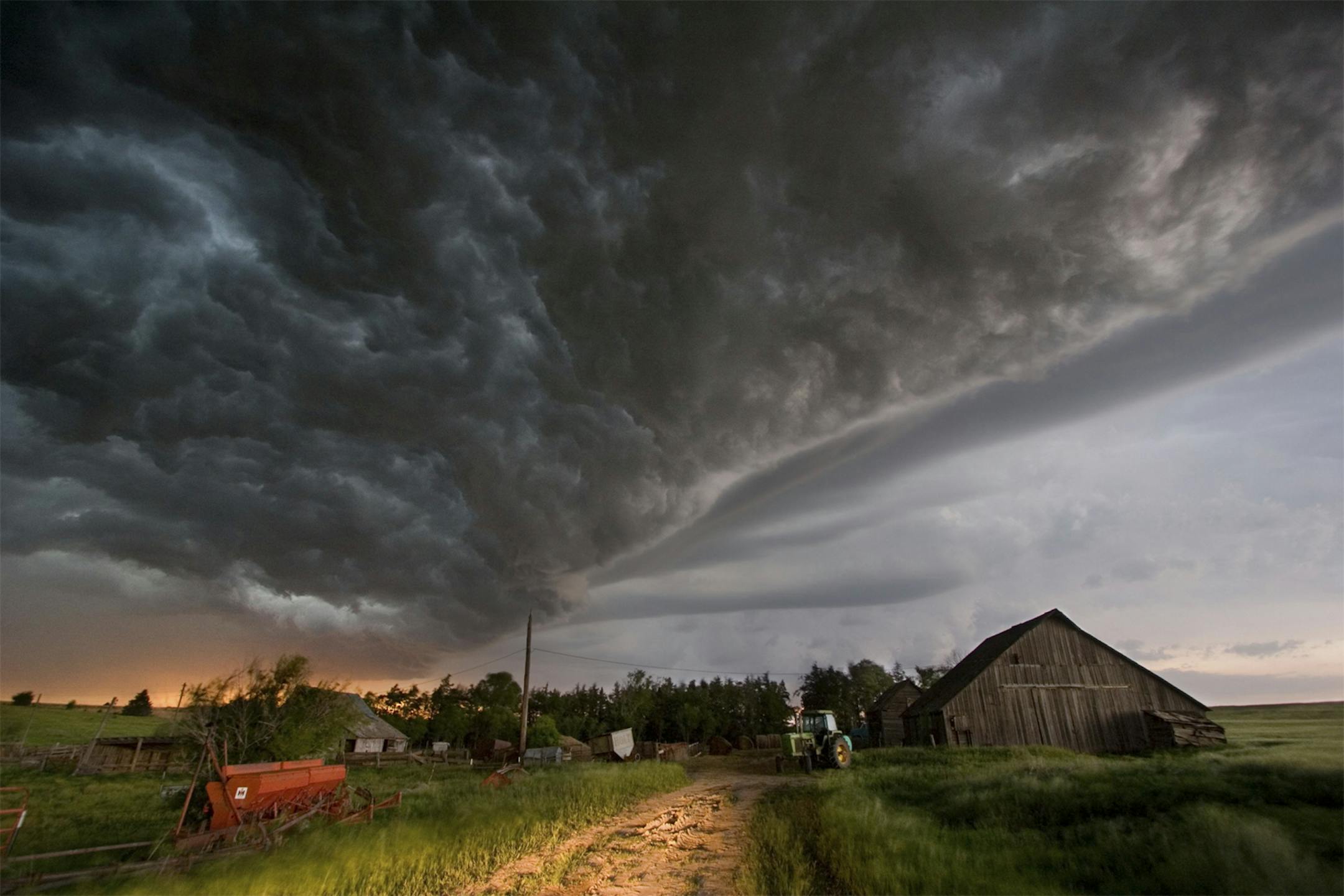 Filmmaker Sean Casey and the scientists of the VORTEX2 severe weather research project put themselves in the center of the weather action in Tornado Alley, a giant screen film that opens in the Science Museum of Minnesota's Omnitheater on September 28. In this photo from the film, a squall line approaches in central Kansas, with a barn and farm equipment in foreground. Photo by Ryan McGinnis.