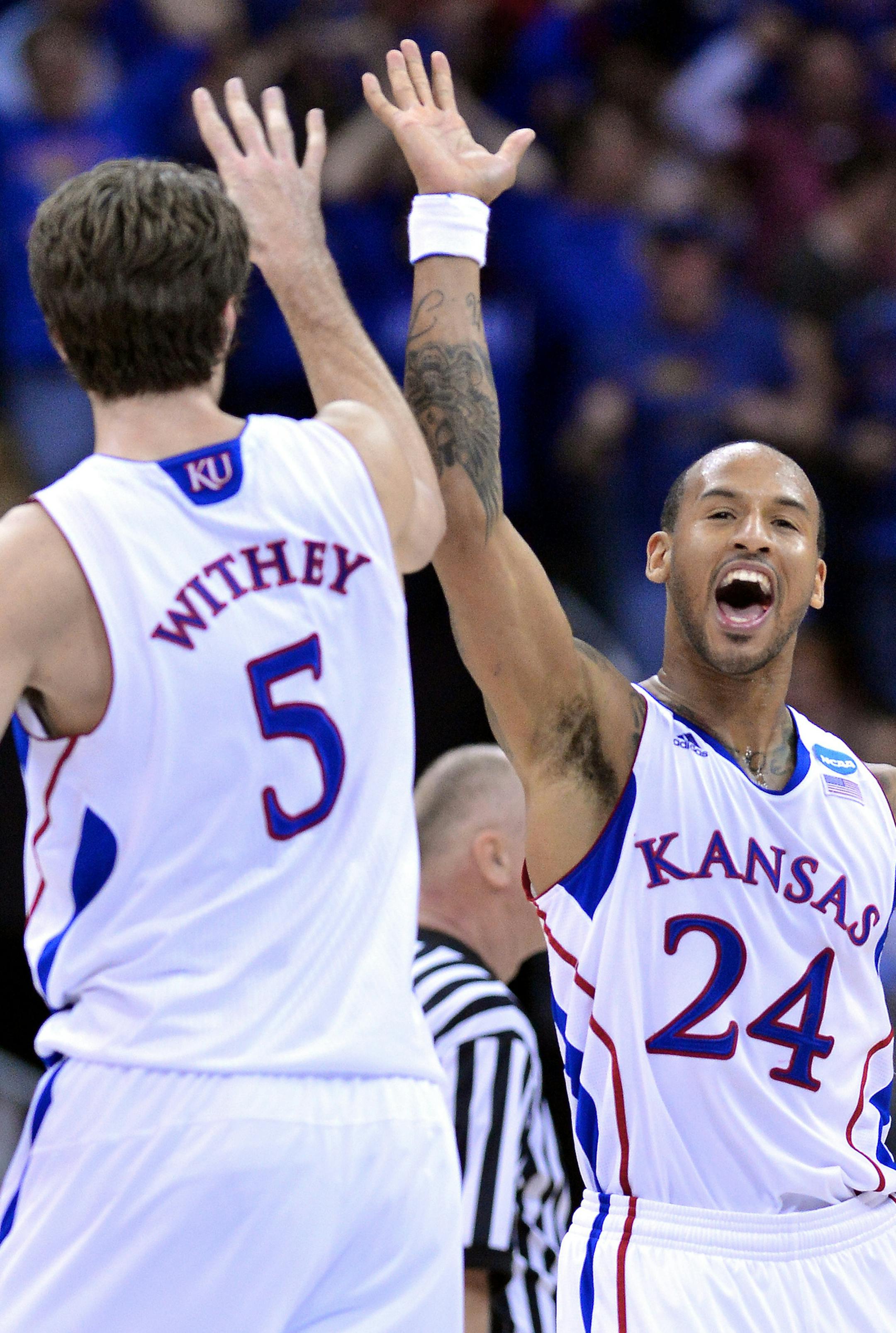 Kansas Jayhawks guard Travis Releford (24) celebrates his basket with center Jeff Withey (5) during third-round action against the North Carolina Tar Heels in the NCAA Tournament at the Sprint Center in Kansas City, Missouri, Sunday, March 24, 2013. Kansas beat UNC, 70-58. (John Sleezer/Kansas City Star/MCT)