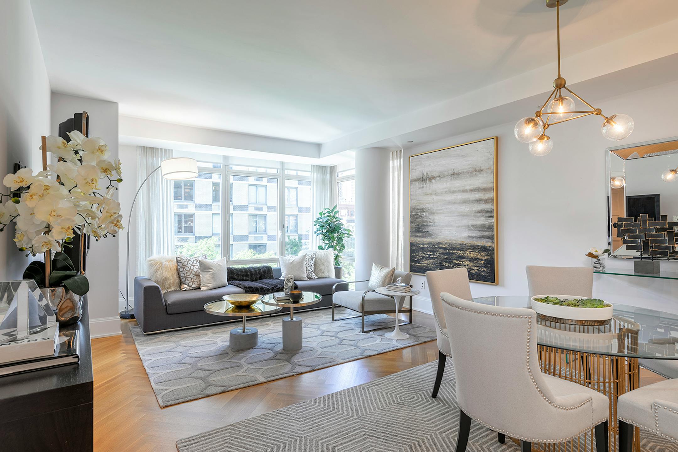 A living room/dining room scene with a glass-topped table.