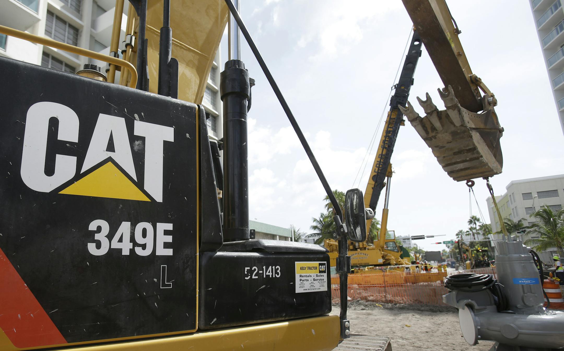 In this Wednesday, Sept. 17, 2014 file photo, a Caterpillar 349E Hydraulic Excavator is shown on a construction site in Miami Beach, Fla. Caterpillar reports earnings Thursday April 23, 2015. (AP Photo/Wilfredo Lee)