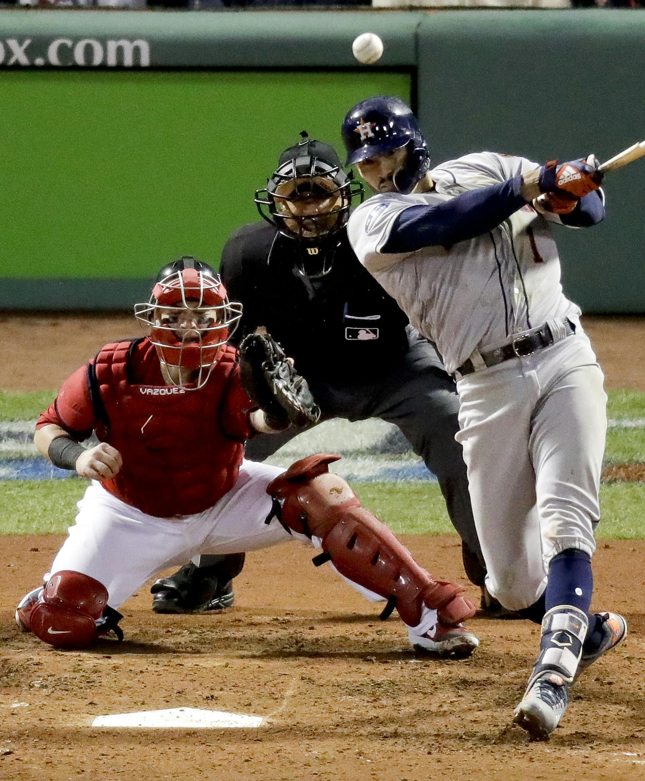 Houston Astros' Carlos Correa watches his RBI-single against the Boston Red Sox during the sixth inning in Game 1 of a baseball American League Championship Series on Saturday, Oct. 13, 2018, in Boston.(AP Photo/Elise Amendola)