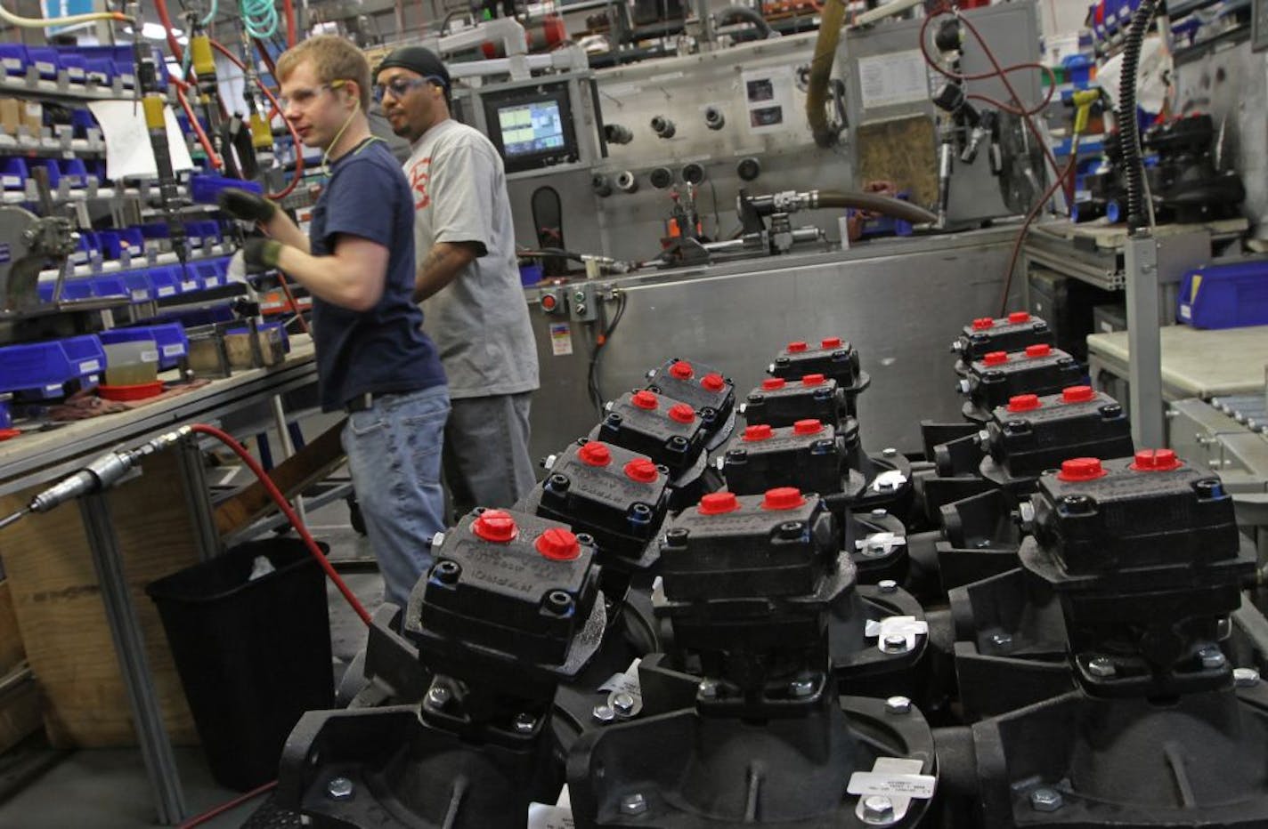 Matthew Pearson and Roydell Greenhil hand assembled Pentair water pumps at the New Brighton assembly plant.