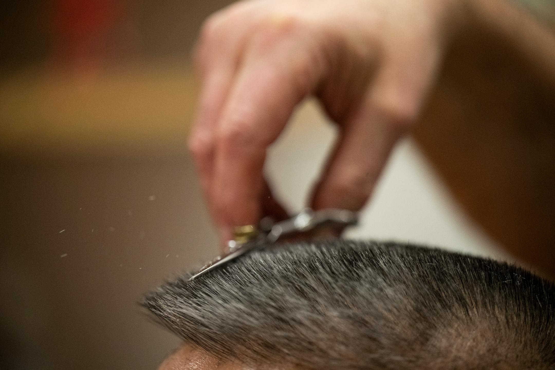 Bob Haddow cuts the hair of longtime client Alan King, a civil litigation and criminal defense attorney.