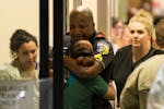 A Dallas Area Rapid Transit police officer receives comfort at the Baylor University Hospital emergency room entrance Thursday, July 7, 2016, in Dalla