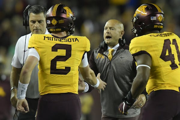 Minnesota Gophers head coach PJ Fleck celebrated with quarterback Tanner Morgan (2) after a second quarter touchdown against the South Dakota State Ja