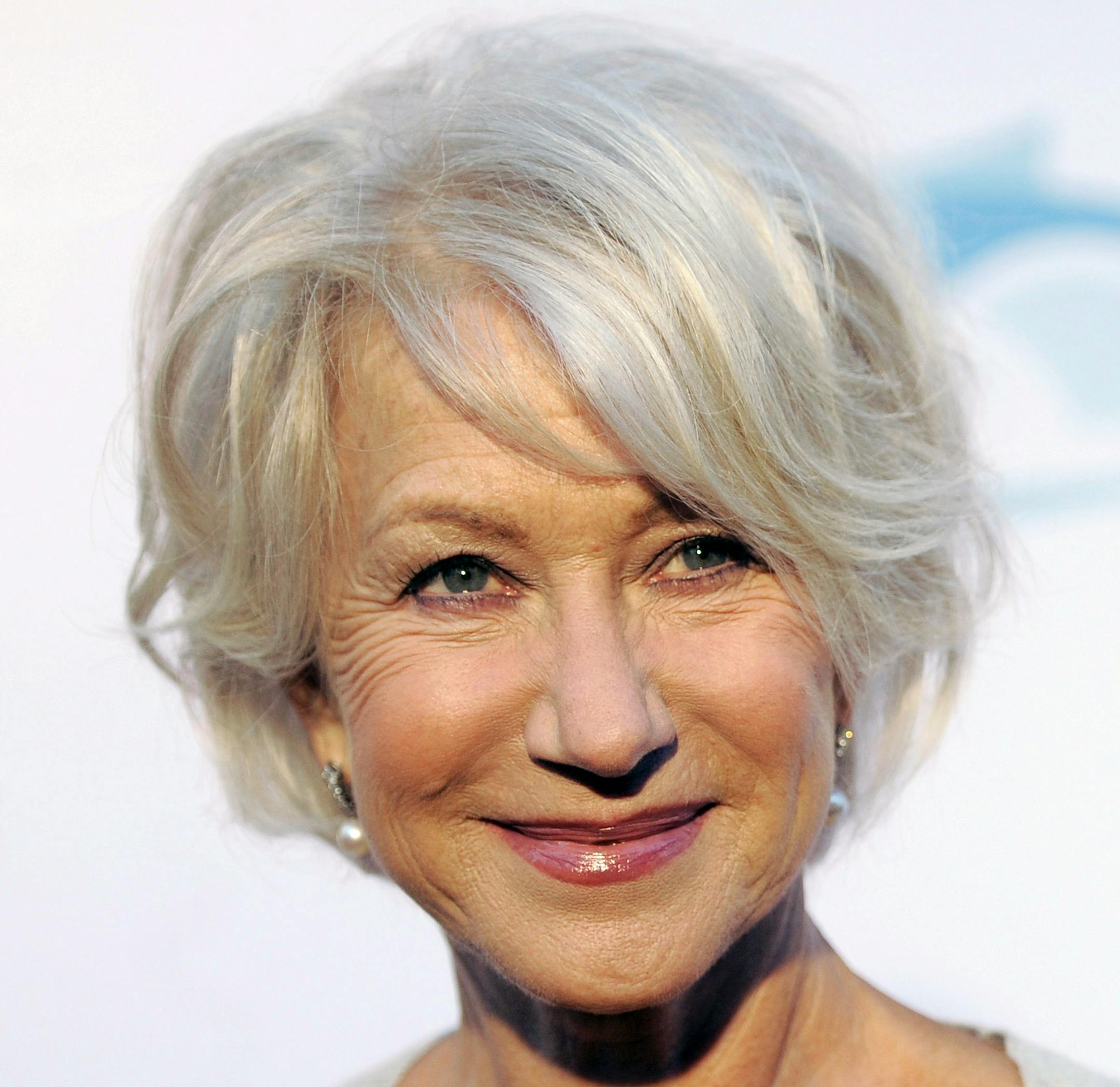 FILE - In this June 17, 2011 file photo, actress Helen Mirren poses at the opening of the 90th season of the Hollywood Bowl in Los Angeles. Gray heads have been popping up on runways and red carpets, on models and young celebrities for months. There's Lady Gaga and Kelly Osbourne _ via dye _ and Hollywood royalty like Oscar-winning British actress Helen Mirren. (AP Photo/Chris Pizzello, file)
