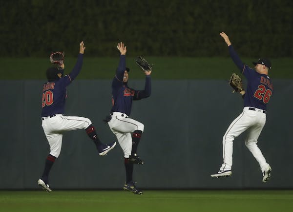 Twins left fielder Eddie Rosario (20), center fielder Byron Buxton, and right fielder Max Kepler (26) took a group jump shot to celebrate the win over