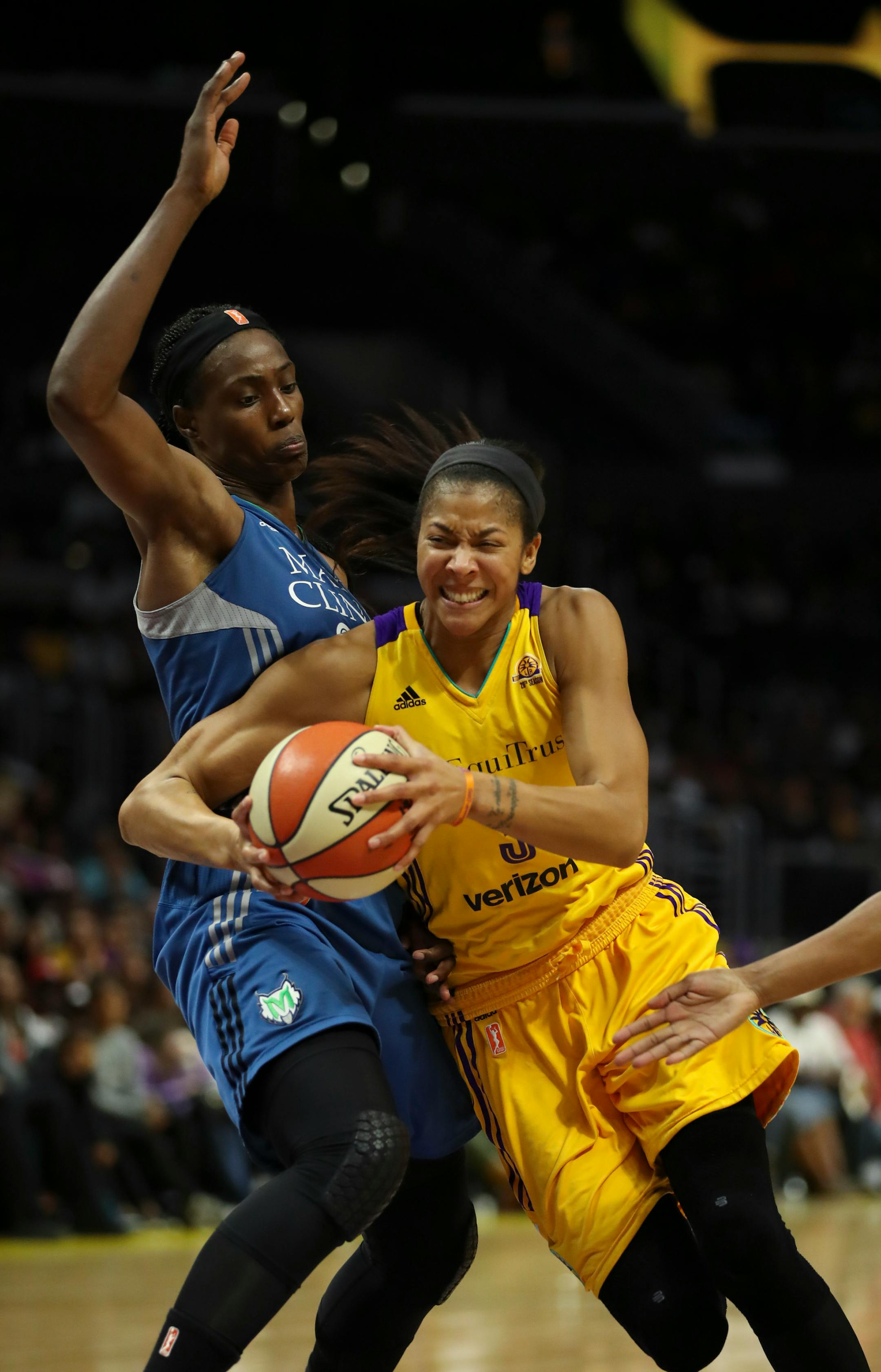 Minnesota Lynx center Sylvia Fowles (34) stood her ground as Los Angeles Sparks forward Candace Parker (3) drove to the net in the fourth quarter.