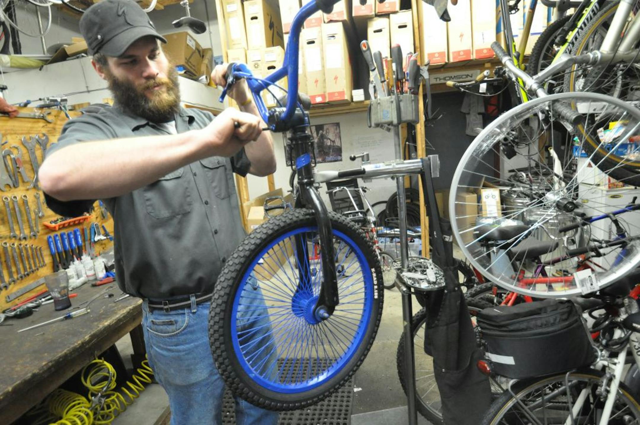 Kip Meers, owner of the Bike King in Inver Grove Heights, worked on a bike to be given away at the city's Holiday on Main Street event. Photo by Liz Rolfsmeier