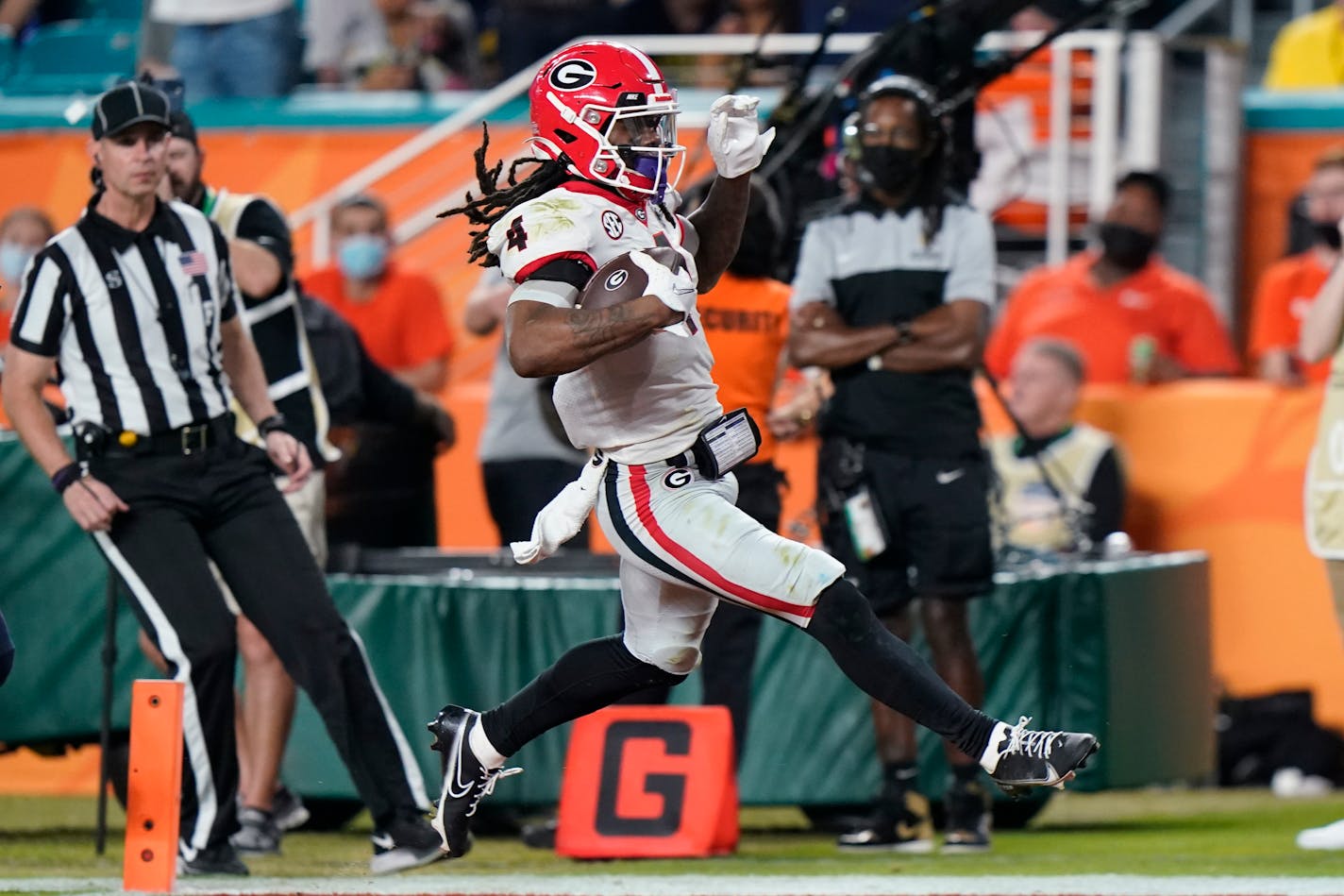 Georgia running back James Cook scores against Michigan during the second half of the Orange Bowl NCAA College Football Playoff semifinal game, Friday, Dec. 31, 2021, in Miami Gardens, Fla. (AP Photo/Lynne Sladky)