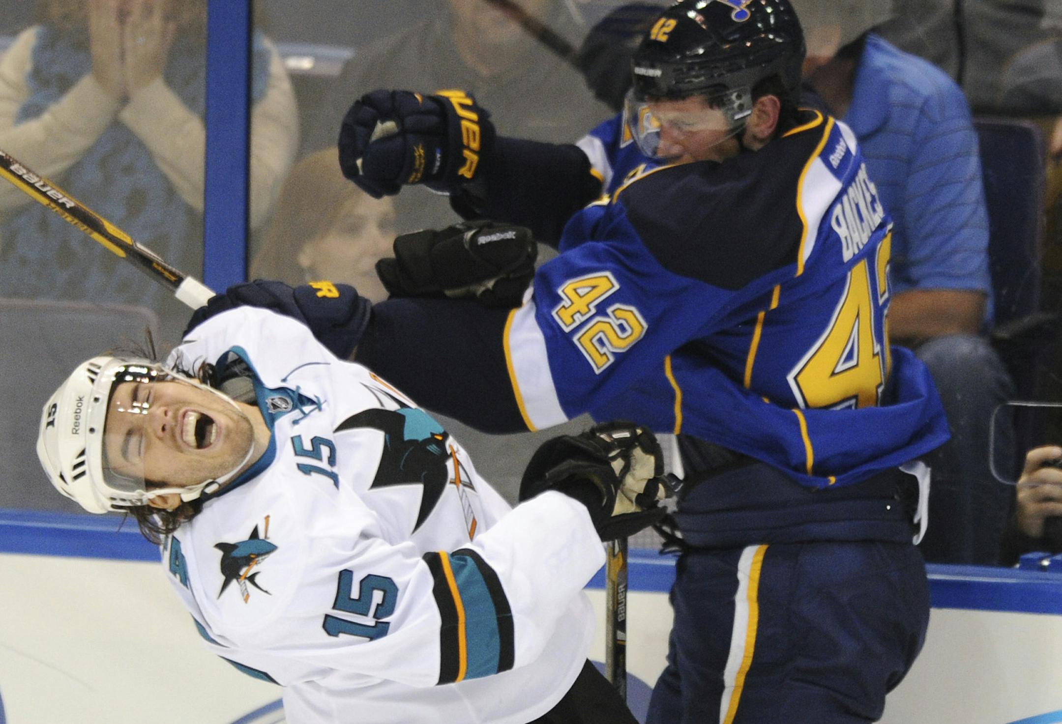St. Louis Blues' David Backes (42) checks San Jose Sharks' James Sheppard (15)