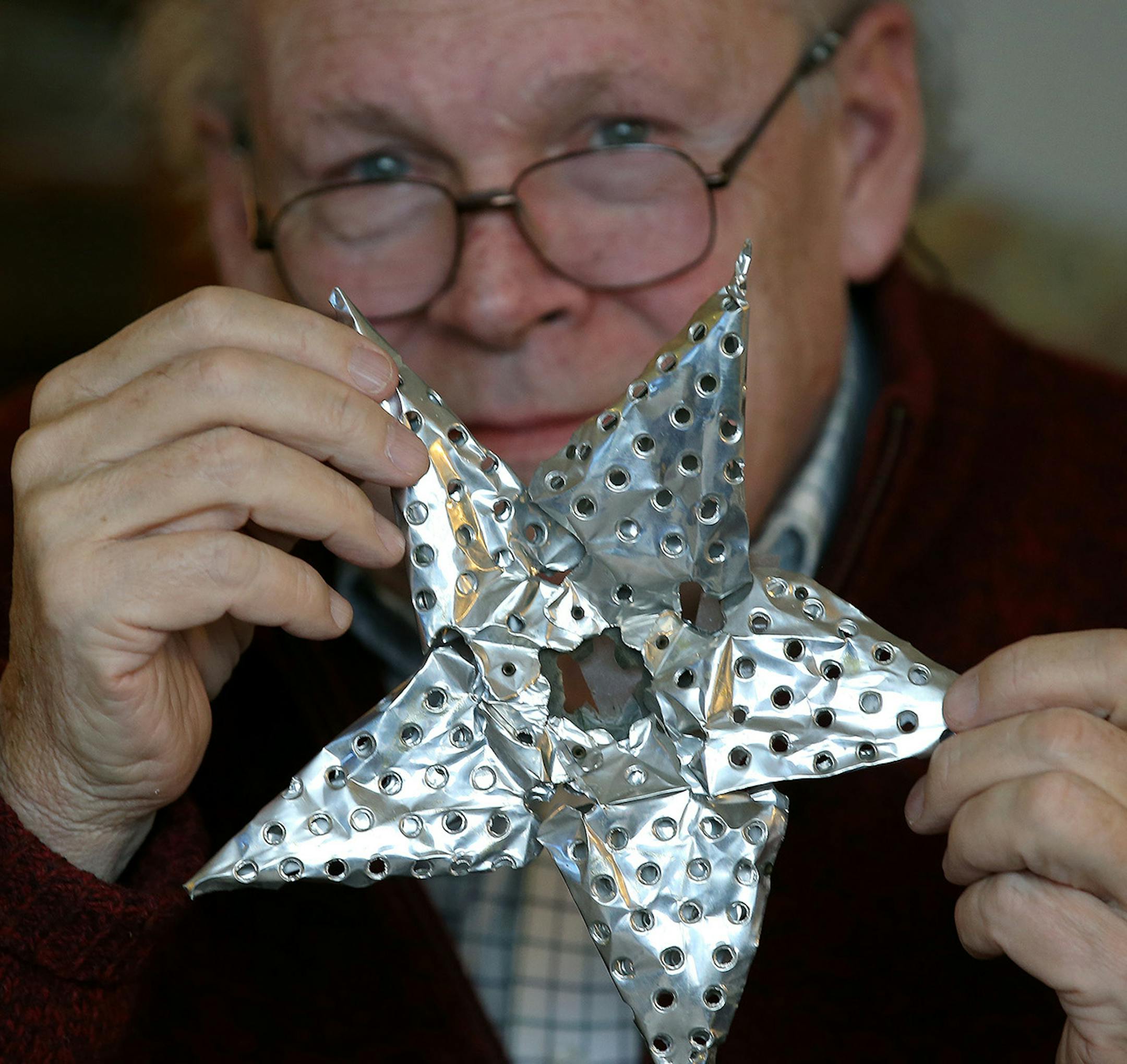Rob Brown showed off an ornament that is sentimental to him and his family, Monday, December 15, 2014 in Minneapolis, MN. It is being held together with four generations of scotch tape. ] (ELIZABETH FLORES/STAR TRIBUNE) ELIZABETH FLORES • eflores@startribune.com