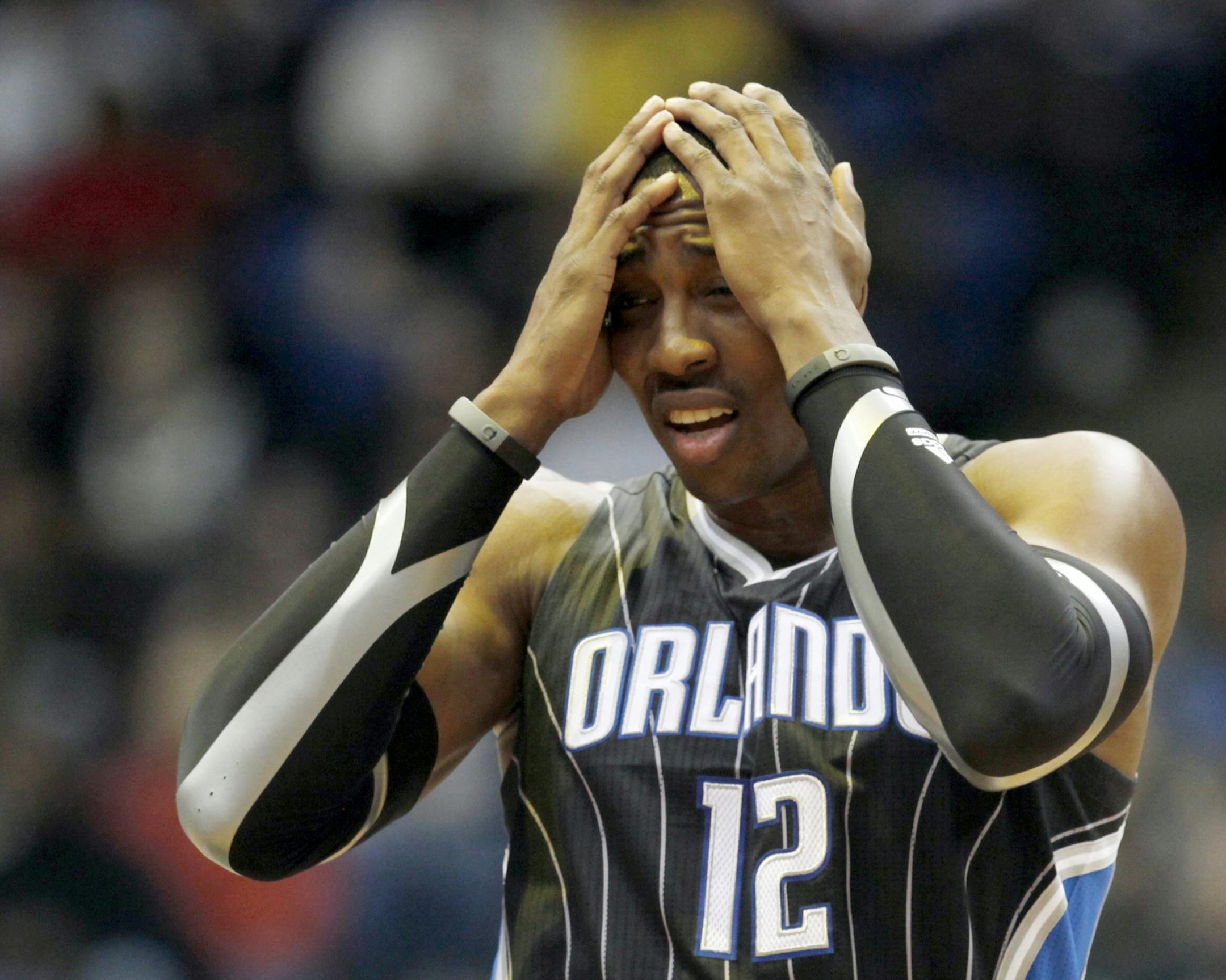 The Orlando Magic versus the Minnesota Timberwolves at the Target Center. In this photo:] First Half. Orlando's Dwight Howard got into first half foul trouble, giving him a seeming headache.