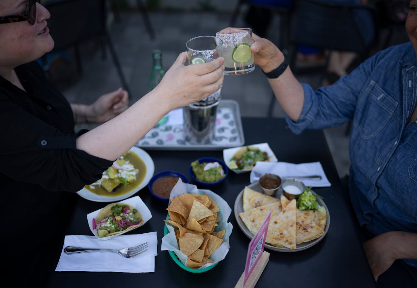 Toasting the evening on the patio of Centro at Popul Vuh Monday evening. ] JEFF WHEELER • jeff.wheeler@startribune.com The patio of Centro at Popul Vuh and Vivir is pleasantly shaded in the evening, making for cool outdoor dining. The patio was busy with diners Monday evening, June 14, 2021 in Northeast Minneapolis.