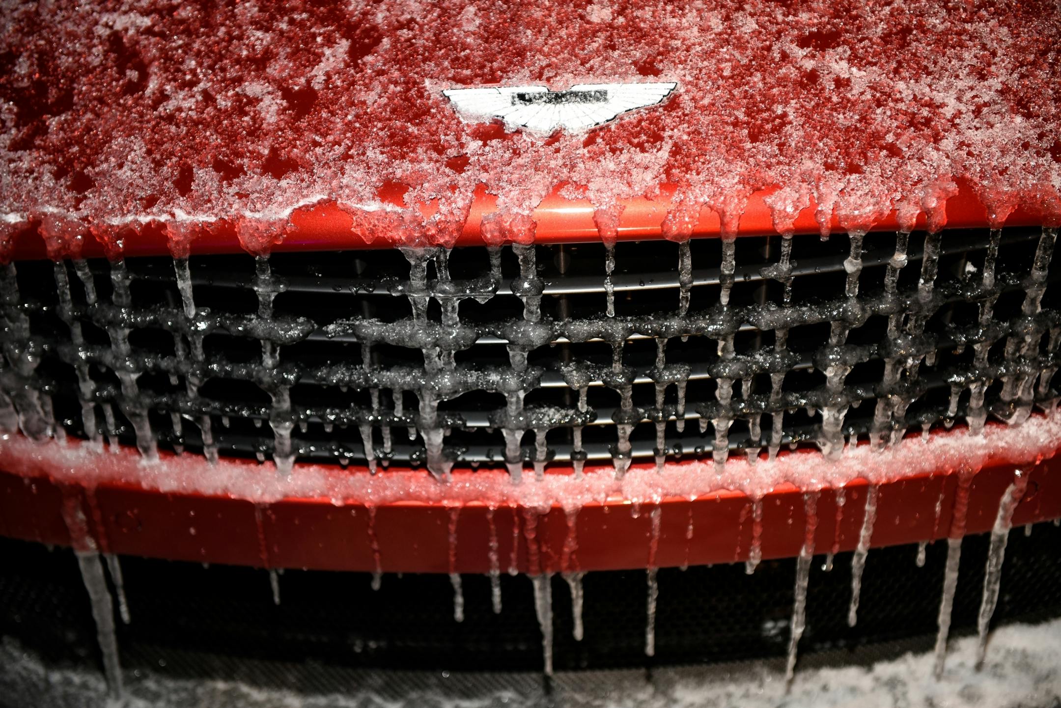 An Aston Martin on display at the "Big Game Big Give" charity party was covered in ice Saturday night.
