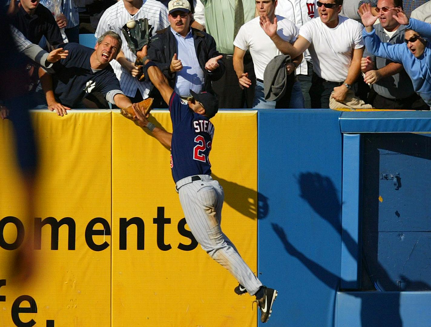 New York, NY 9/30/2003 Twins -vs- Yankees Twins left fielder Shannon Stewart fends off the fans and robs New York Yankees Hideki Matsui of a home run in the top of the 9th inning.