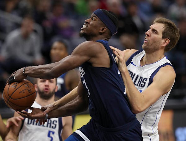 Dallas Mavericks forward Dirk Nowitzki (41) fouled Minnesota Timberwolves guard Jimmy Butler (23) on his way to the net in the fourth quarter.