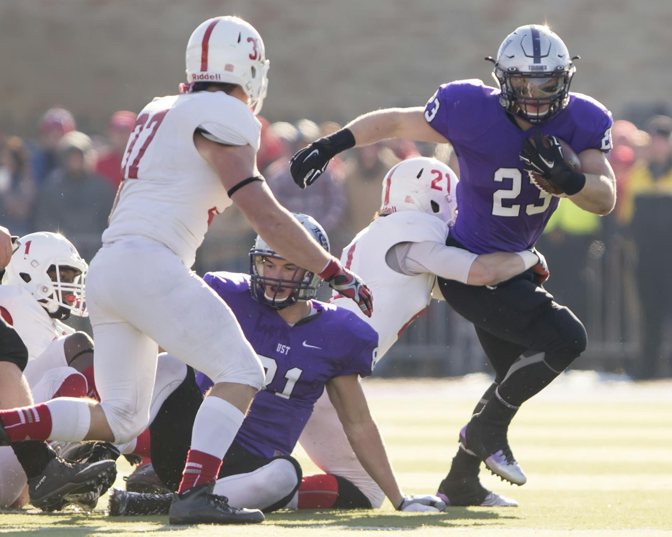St. Thomas running back Jordan Roberts (23) is tackled by St. John's defensive back Lucas Glomb (21) as the University of St. Thomas Tommies hosted the St. John's University Jonnies on November 28, 2015. ] Special to Star Tribune MATT BLEWETT &#xef; matt@mattebphoto.com - November 28, 2015, Hopkins, MN, University of St. Thomas Tommies, St. John's University Jonnies, NCAA Division III Football, University of St. Thomas Tommies vs. St. John's University Jonnies, 650569 Reusse112915