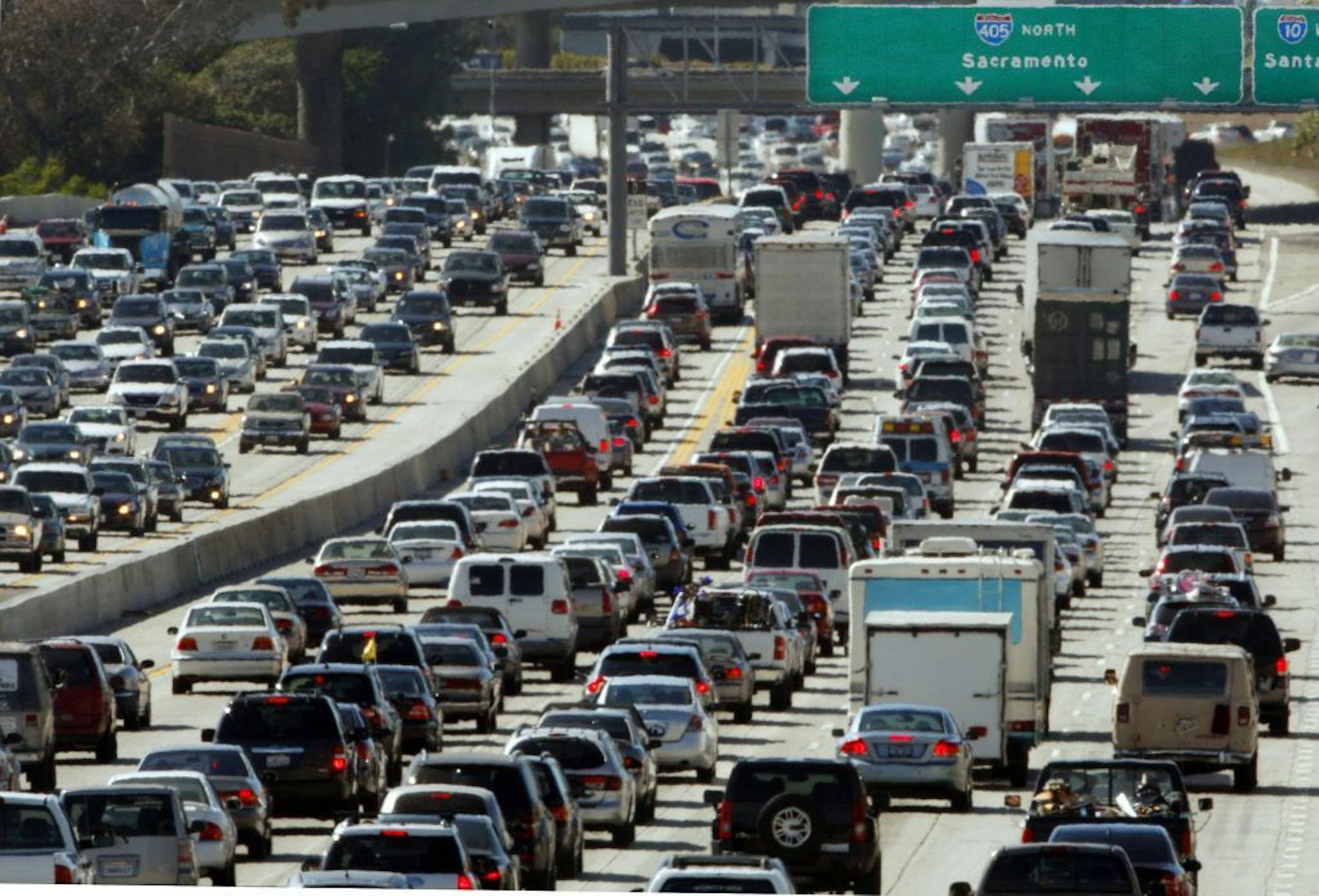 FILE - In this May 28, 2010 file photo, the rush hour commute starts in early afternoon and with greater intensity as traffic is jammed in both directions on Interstate 405 on the Westside of Los Angeles as commuters and vacationers hit the road. Cheaper gas won�t be enough to spur many more road trips this summer. Americans are too worried about their jobs and the economy to feel relief. Economists and tourism experts are expecting only a small uptick in summer travelers. Gas prices are lower,