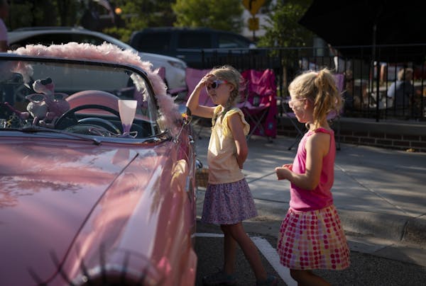 Avery and her sister Katilyn, of Victoria, checked out a classic pink Thunderbird during Classic Car Night last week in downtown Victoria.