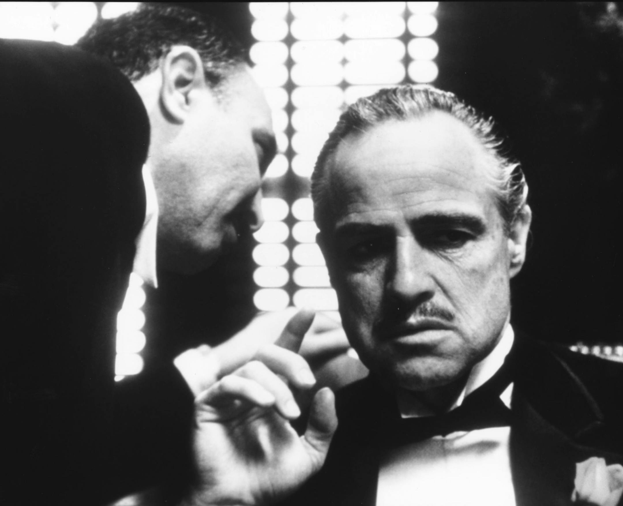 Marlon Brando (at right) stars as Don Vito Corleone, and Salvatore Corsitto (left) as undertaker Bonasera in the 1972 movie classic "The Godfather," directed by Francis Ford Coppola, based on the book by Mario Puzo. File photo courtesy of Paramount Pictures.