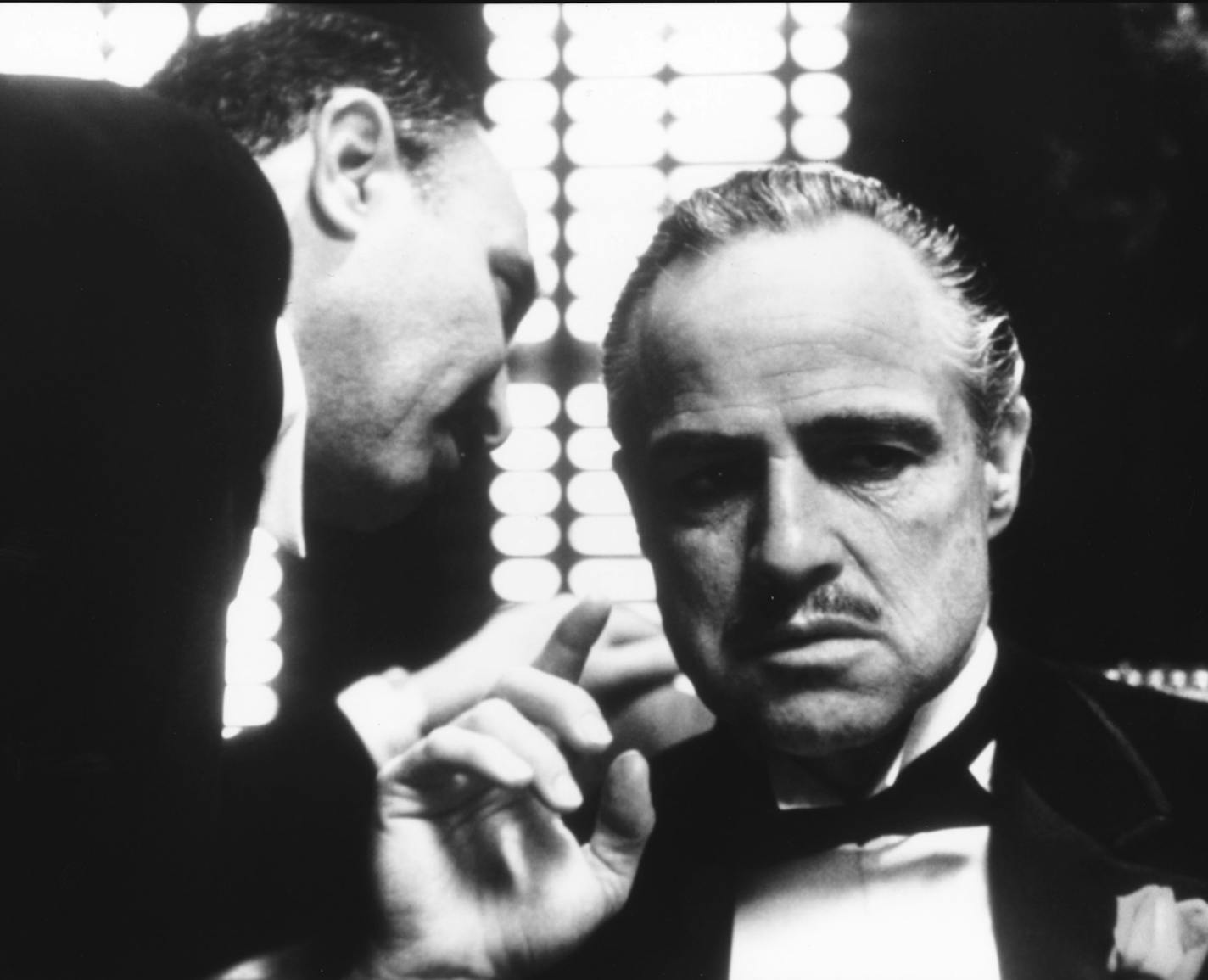 Marlon Brando (at right) stars as Don Vito Corleone, and Salvatore Corsitto (left) as undertaker Bonasera in the 1972 movie classic "The Godfather," directed by Francis Ford Coppola, based on the book by Mario Puzo. File photo courtesy of Paramount Pictures.