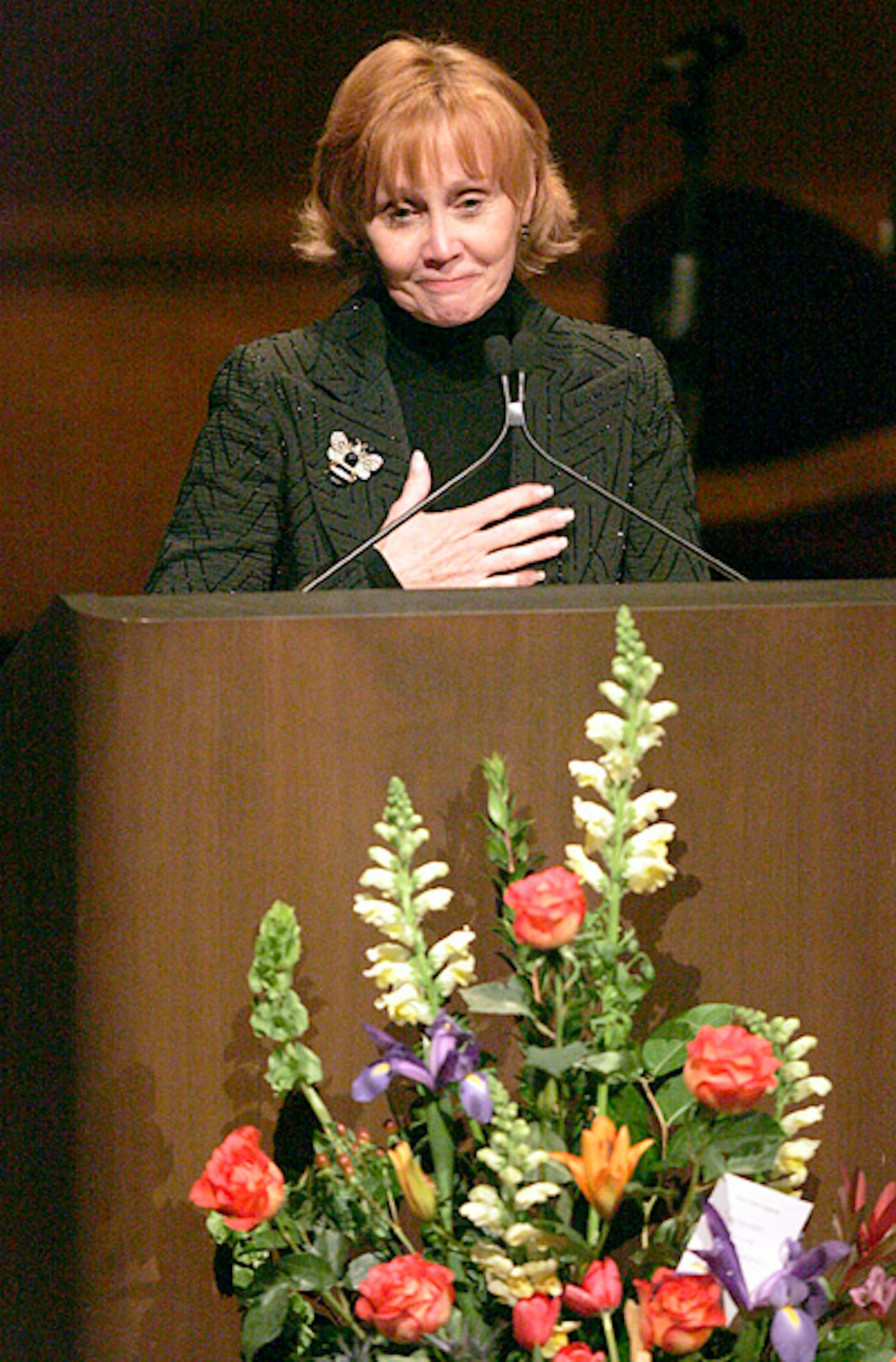 Nancy Nelson, wife of Bill Carlson, spoke during a memorial service for him at State Theater in Minneapolis.