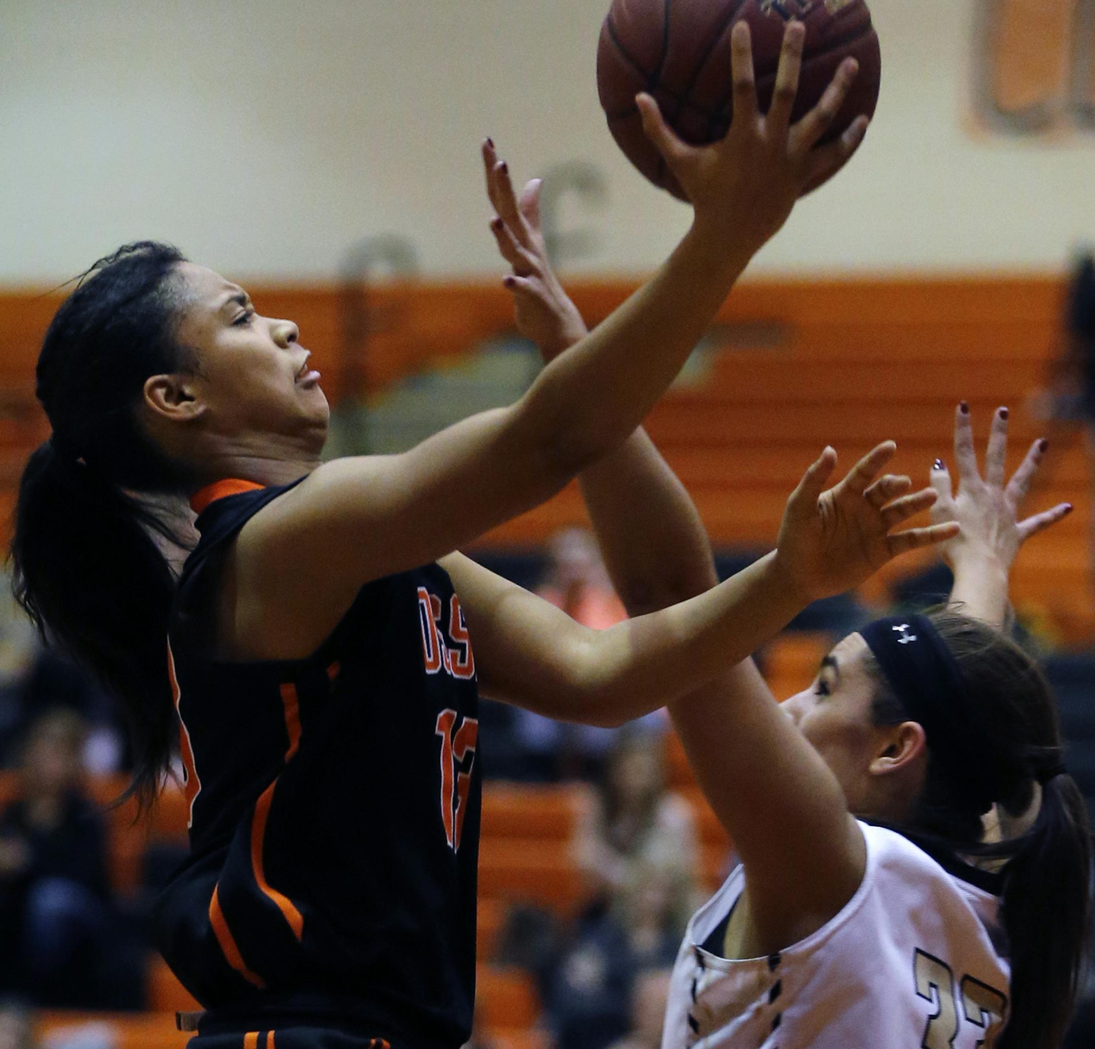 At Osseo H.S. in a girls' basketball game between Osseo and Andover, Kiara Russel(13) of Osseo goes for a layup with Gabriella Garcia(33) defending.] Richard Tsong-Taatarii/rtsong-taatarii@startribune.com