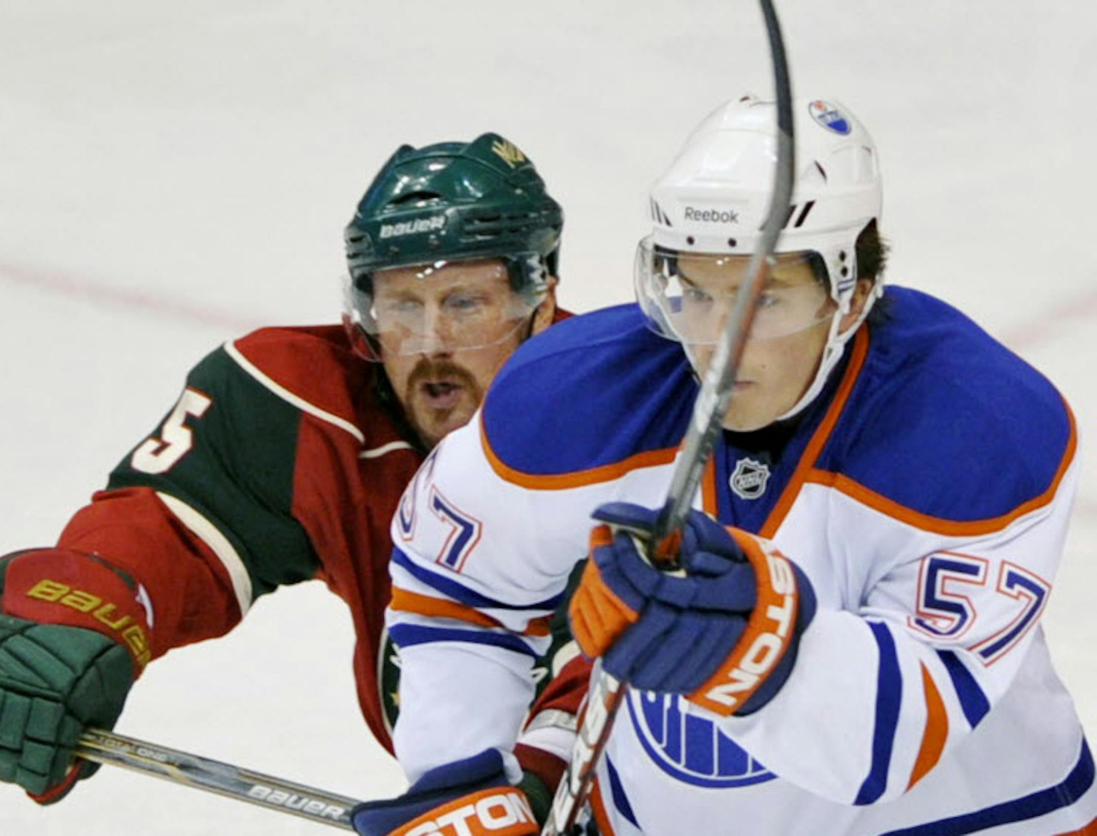 Wild defenseman Greg Zanon (left)