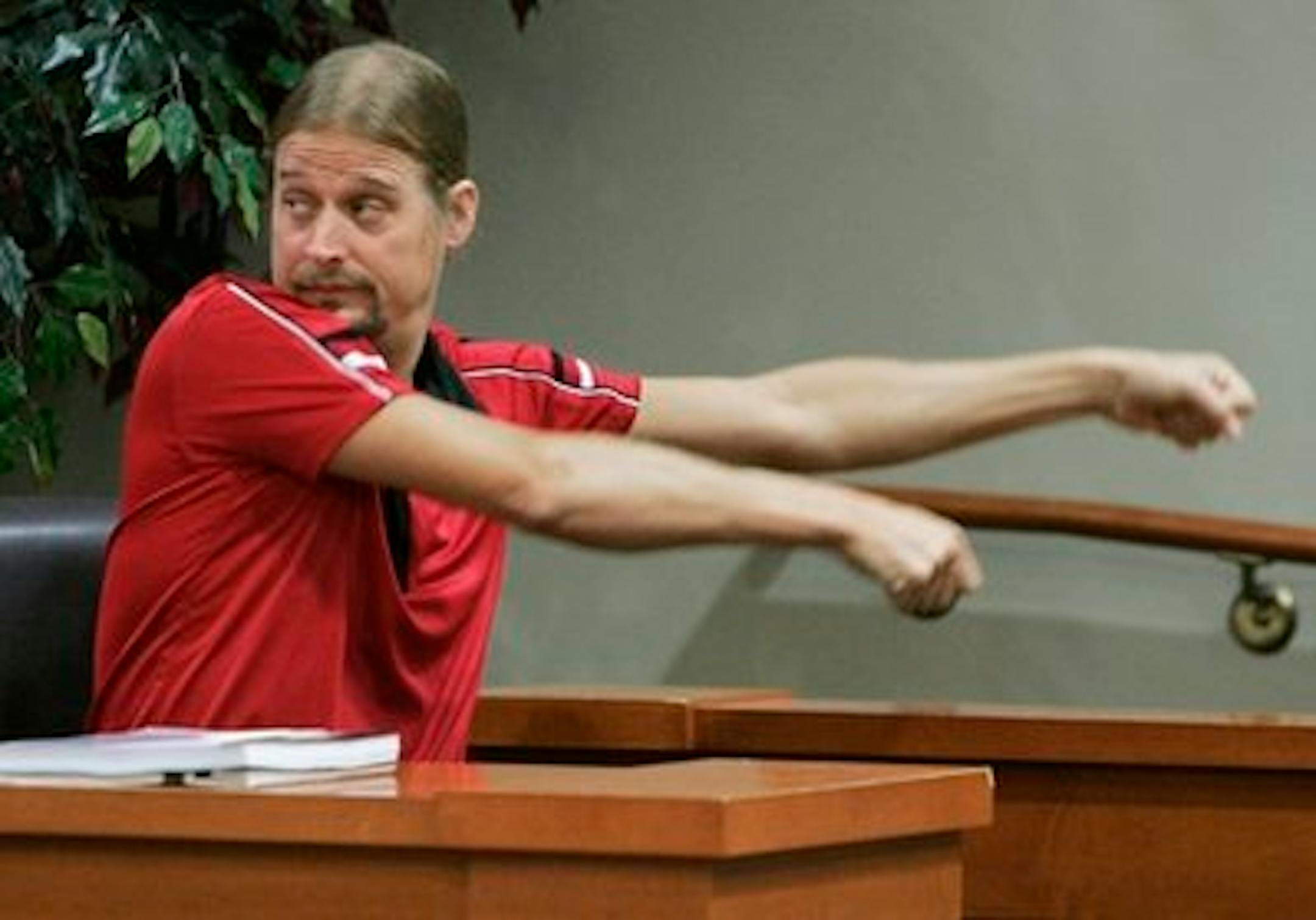 Robert James Ritchie, also known as Kid Rock, demonstrates picking up a chair while testifying on his own behalf in a civil trial in Decatur, Ga., Thursday, Sept. 16, 2010. Harlen Akins claims Ritchie and members of his entourage attacked him during an early-morning fight at a Waffle House in October 2007.  (AP Photo/John Amis)
