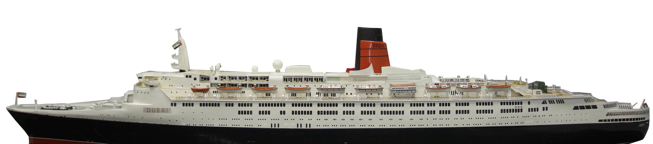 Khamis Juma Buamin, chairman of shipyard operator Drydocks World, poses with a model of a 46-year-old Queen Elizabeth 2 during a press conference in Dubai, United Arab Emirates, Sunday, July 7, 2013. The ship is undergoing upgrades in Dubai before its planned Oct. 18 departure. An official involved in the transformation of the storied passenger liner Queen Elizabeth 2 into a floating hotel said the ship will set sail in October for Asia to begin the $90 million overhaul. (AP Photo/Kamran Jebreil