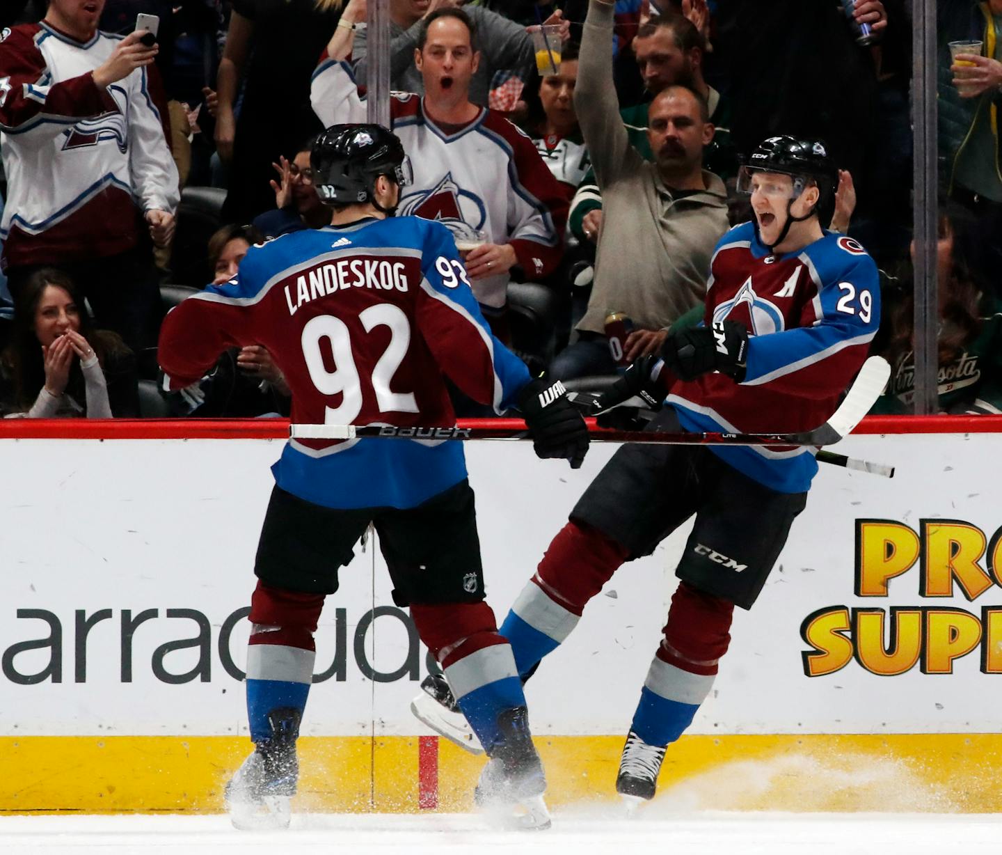 Colorado Avalanche left wing Gabriel Landeskog, left, celebrates with center Nathan MacKinnon after his goal against the Minnesota Wild in the second period of an NHL hockey game Friday, March 2, 2018, in Denver. (AP Photo/David Zalubowski)