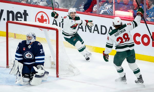 The Wild's Mats Zuccarello and Ryan Hartman celebrate Hartman's goal against Jets goaltender Connor Hellebuyck during the second period Wednesday
