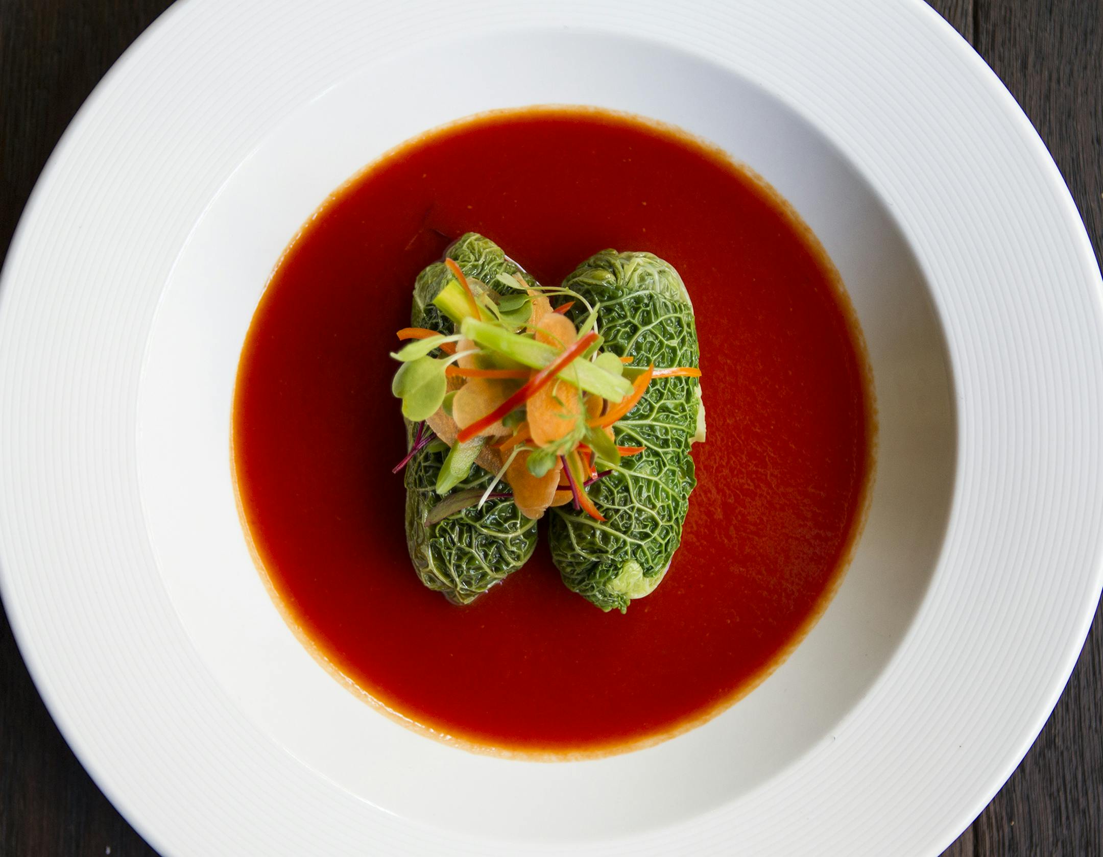 Vegetable holishkes are cabbage leaves stuffed with spring vegetables and organic kamut berries with a sweet and sour tomato sauce at Brasserie Zentral in Minneapolis.