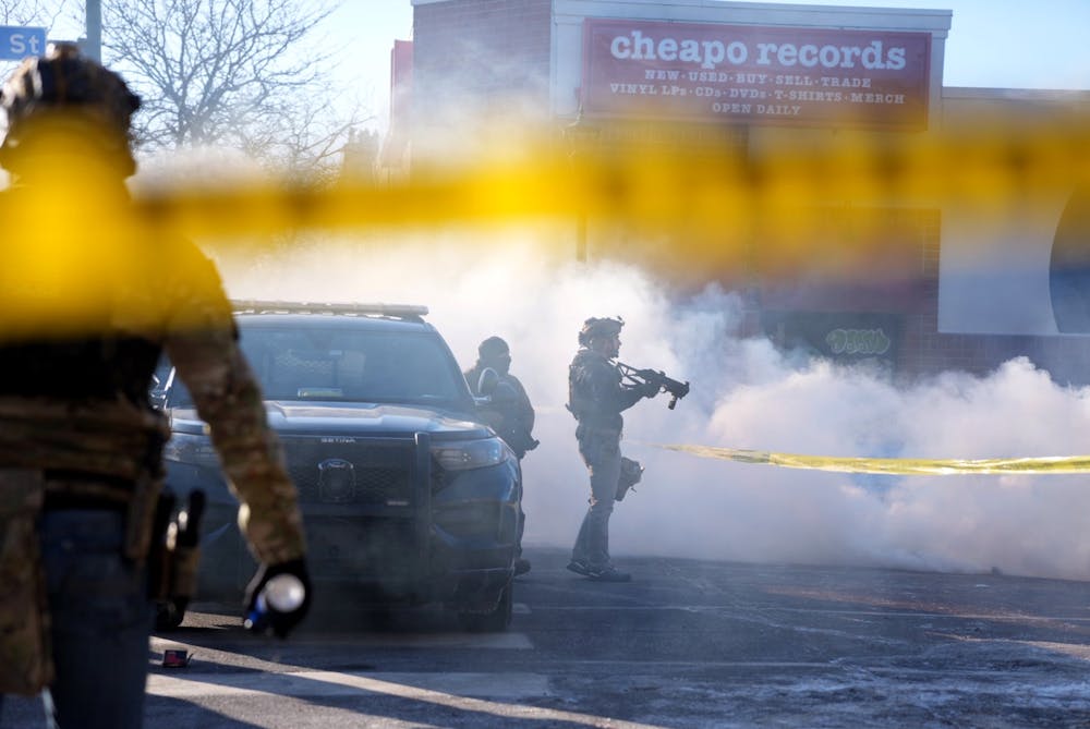 Federal agents attempt to control a growing crowd on Nicollet Avenue a agent fatally shot a person there on Saturday, Jan. 24.