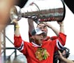 Chicago Blackhawks' Patrick Kane holds up the Stanley Cup during a rally celebrating the NHL hockey club's Stanley Cup championship, Thursday, June 18