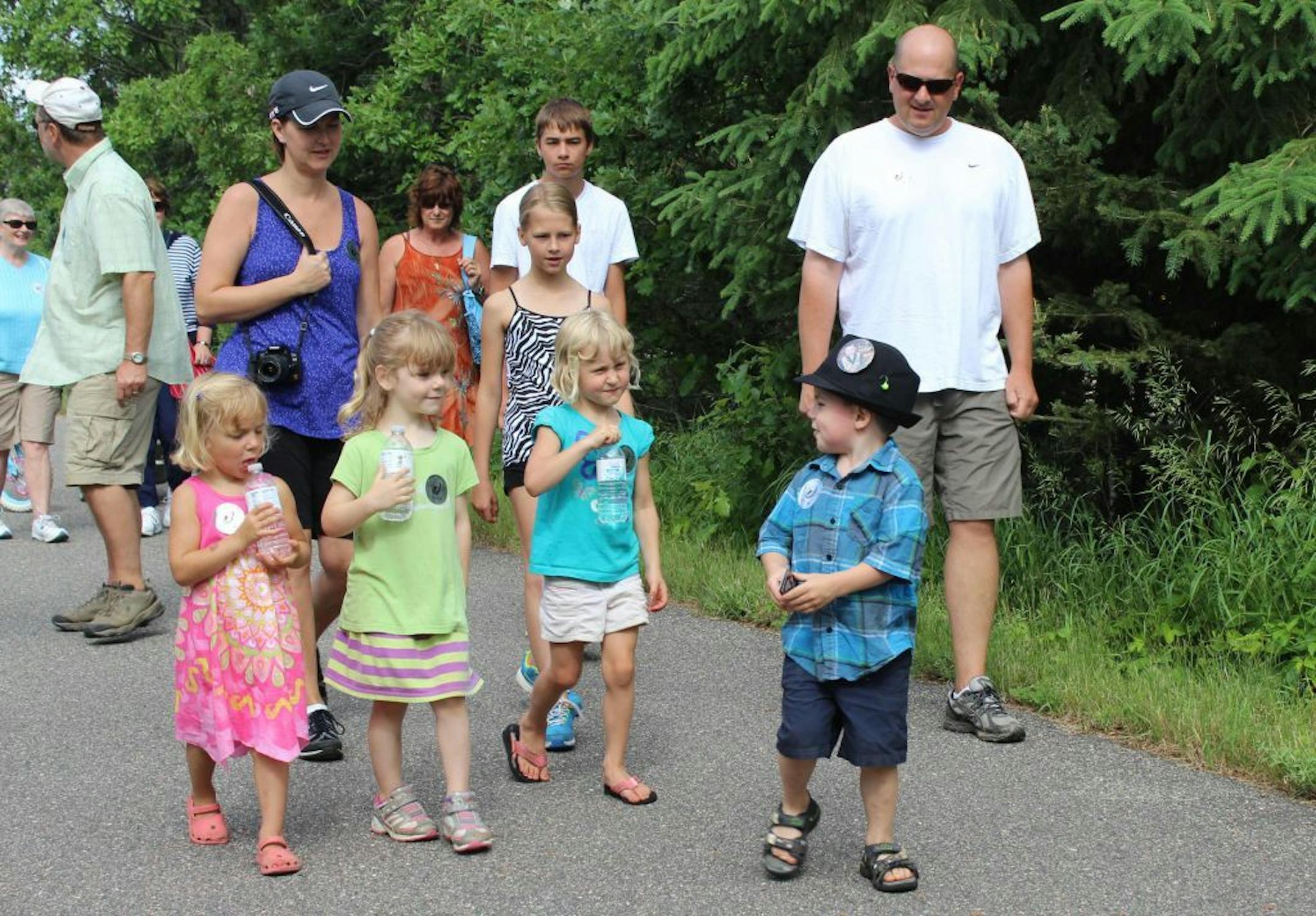 Bobby Tufts, the small town's 4-year-old mayor, front, leads children and adults in the Ronald McDonald fundraising walk.