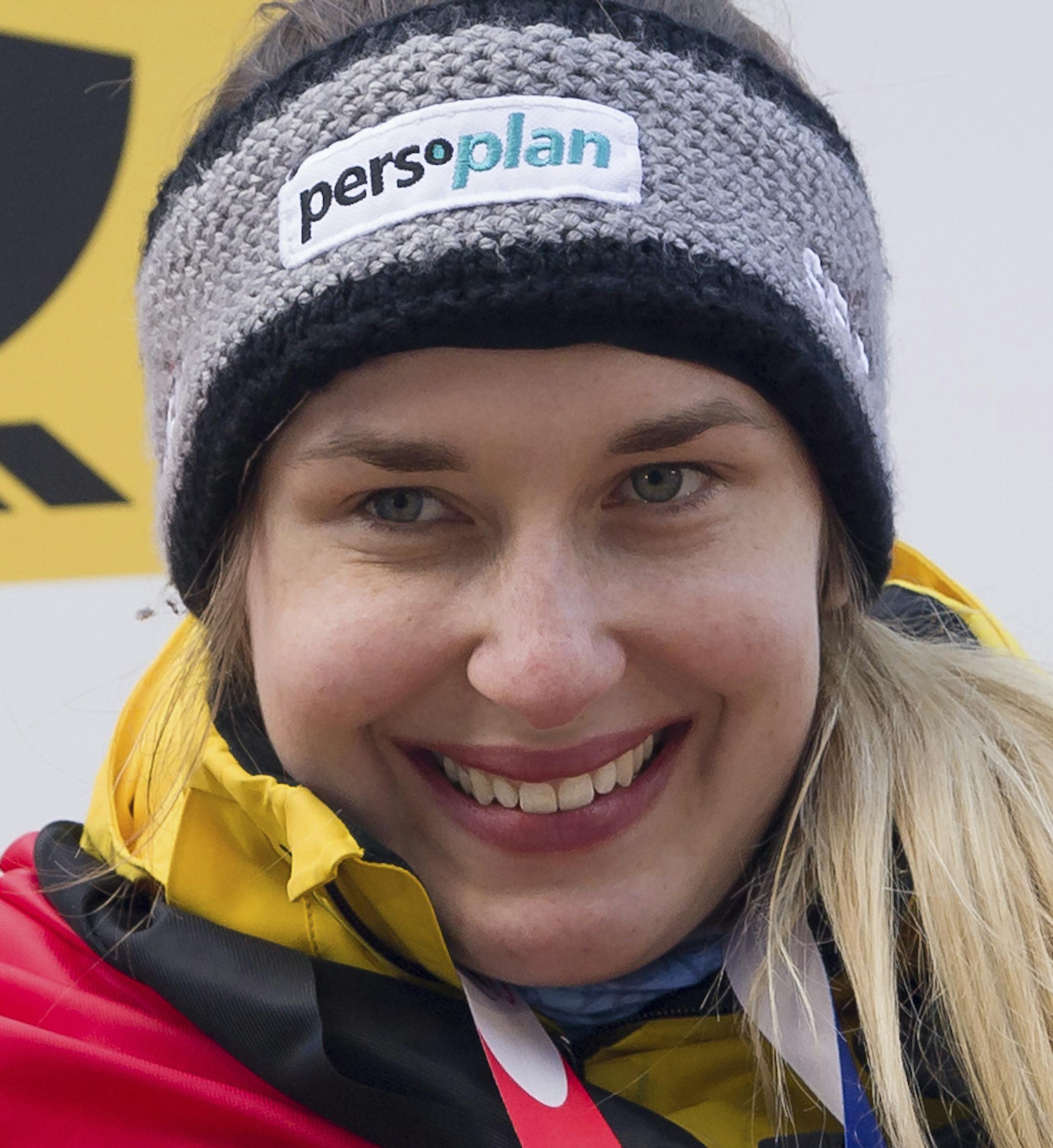 Skeleton racers second placed Germany's Tina Herrmann, Germany's winner Jacqueline Loelling and third placed Britain's Lizzy Yarnold celebrate on the podium during the medal ceremony at the bob and skeleton World Championships in Schoenau am Koenigssee, Germany, Saturday, Feb. 25, 2017. (Peter Kneffel/dpa via AP)