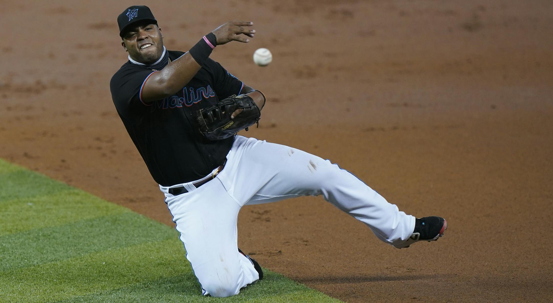 Miami Marlins first baseman Jesus Aguilar throws to first in an attempt to put out Atlanta Braves' Adam Duvall during the second inning of a baseball game, Friday, Aug. 14, 2020, in Miami. (AP Photo/Wilfredo Lee)