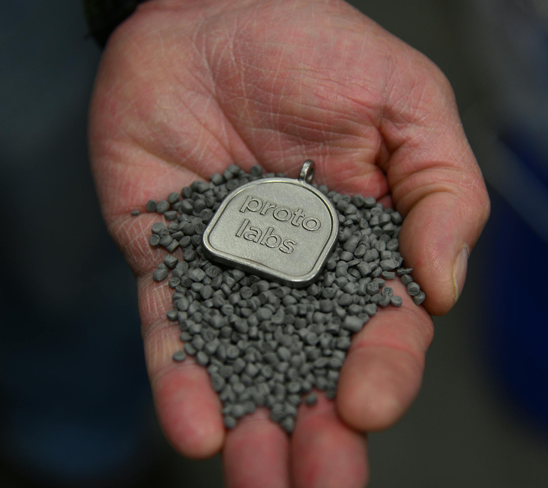 Daren Braun held a stainless steel promotional part in a hand full of stainless steel beads. ] Proto Labs invested $3 million and now will offer steel and rubber injection molding services in addition to its traditional plastic contract-manufacturing work. New business division will be in Maple Plain, Minn Richard.Sennott@startribune.com Richard Sennott/Star Tribune Maple Plain Minn. FRiday 4/11/2014) ** (cq)